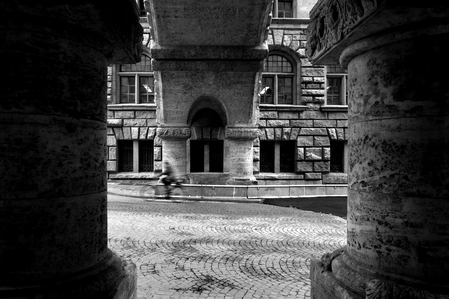 Black and white photograph of a cyclist on a street in Leipzig, Germany