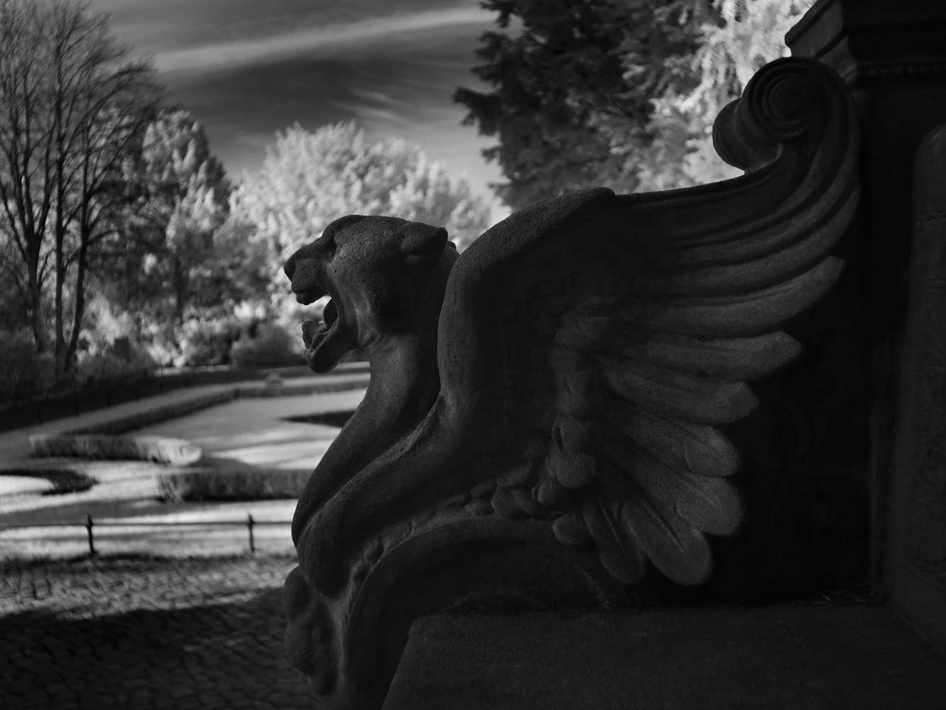 A winged demon. Bench decoration at Südfriedhof Magdeburg, Germany. Mark Robert Davey