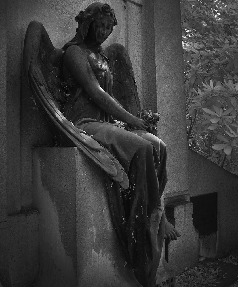 Black and white infrared photograph of an angel in a cemetery