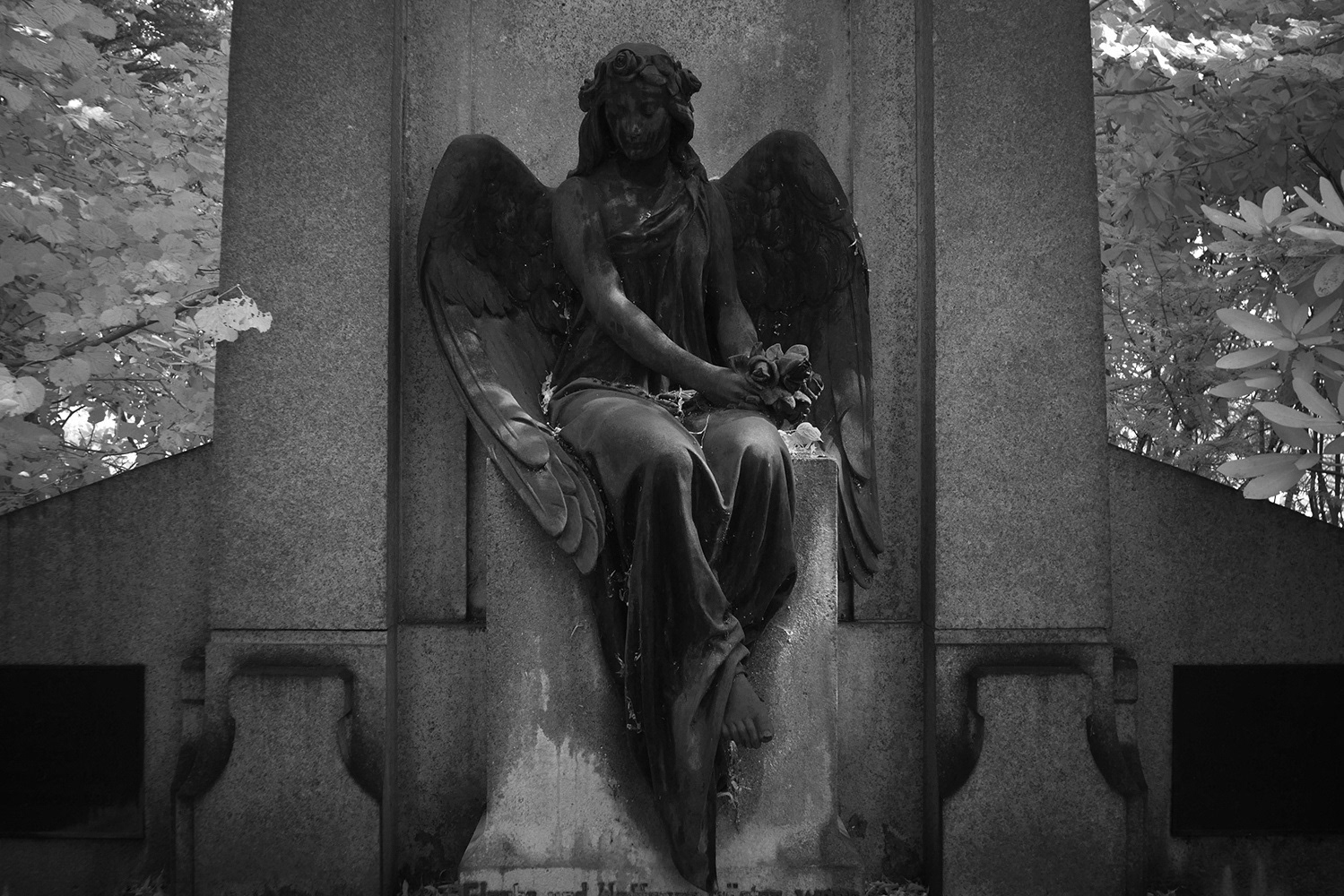 Black and white photograph of a guardian angel waiting at Ohlsdorf cemetery Hamburg Germany