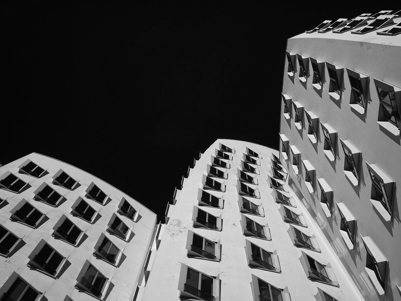 Black and white infrared photograph of the Gehry buildings in Dusseldorf, Germany