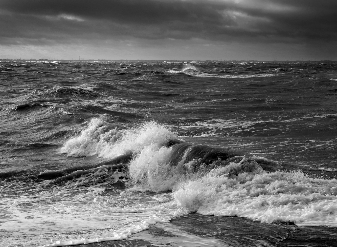 Black and white photograph by Mark Robert Davey of a raging sea and waves.