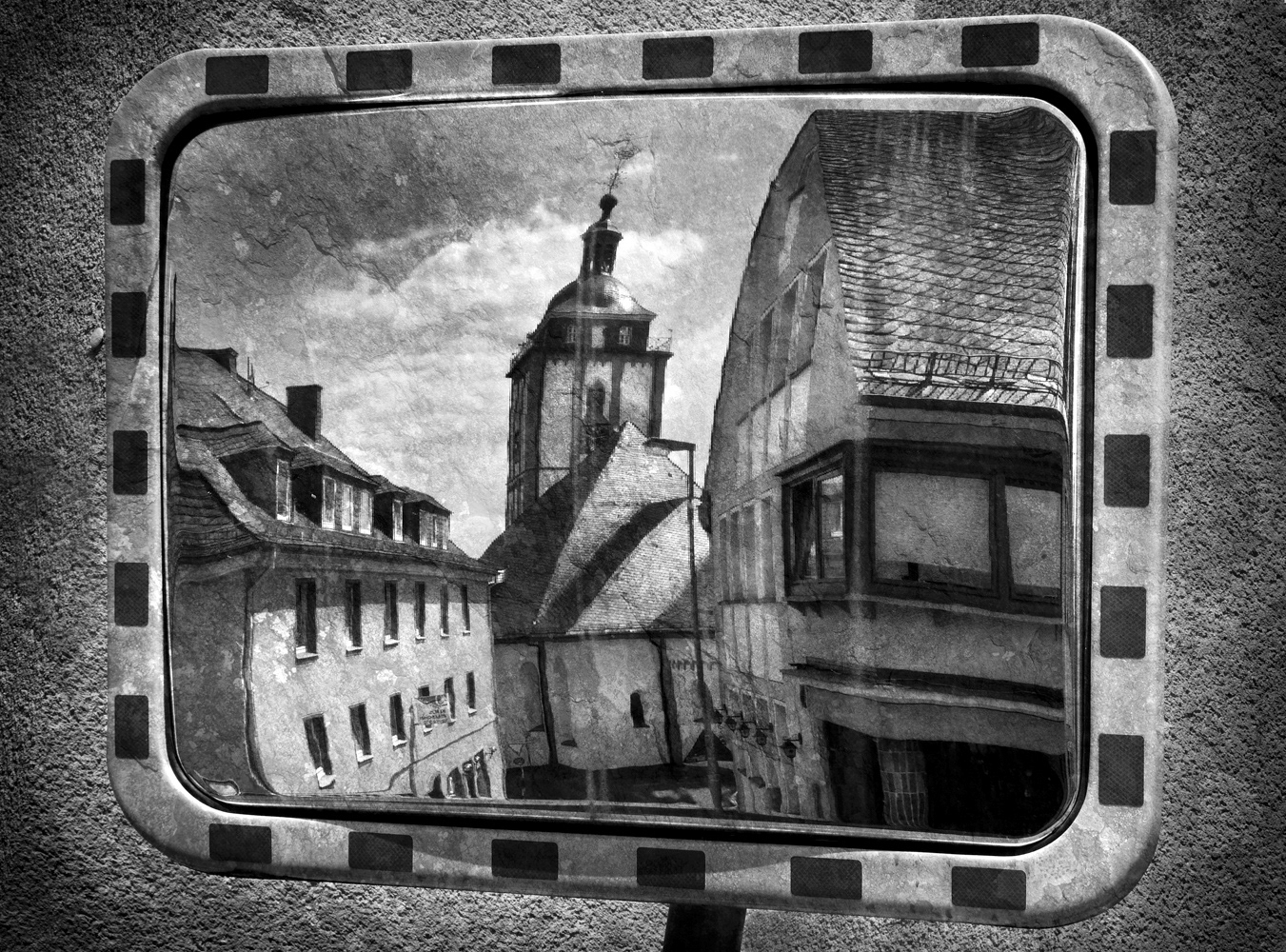 Black and white photograph of buildings reflected in a mirror in Siegen, Germany.