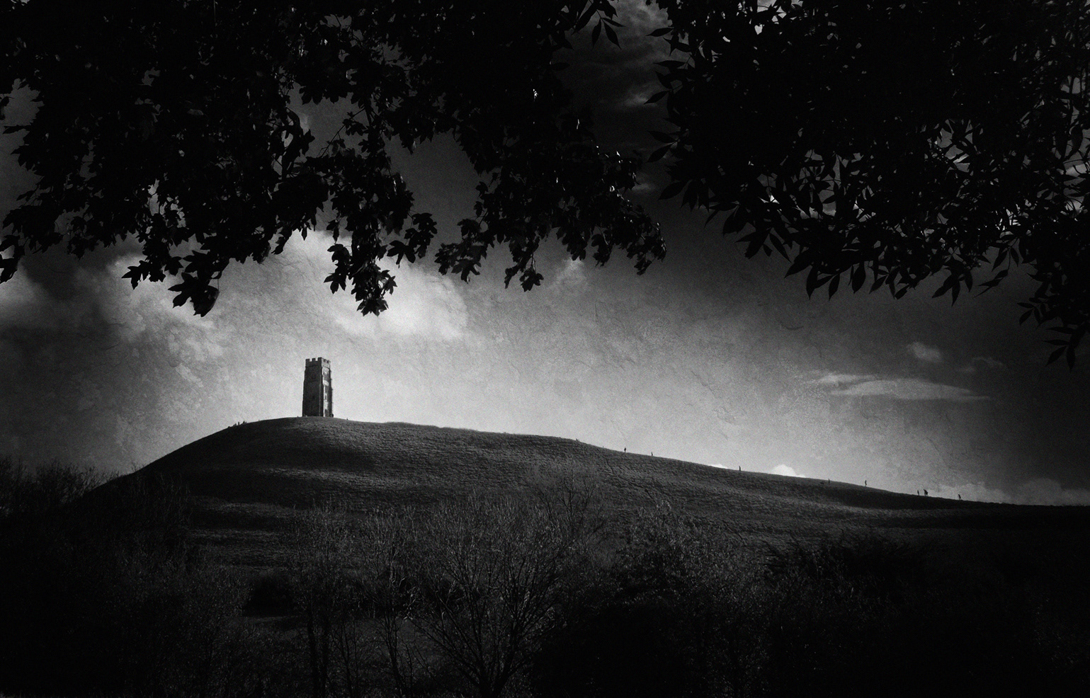 Black and white photograph of Glastonbury Tor, England.