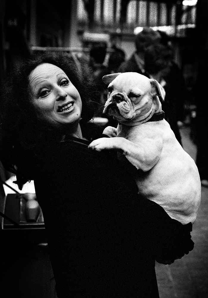 black and white photograph in Paris of a lady holding her bulldog.