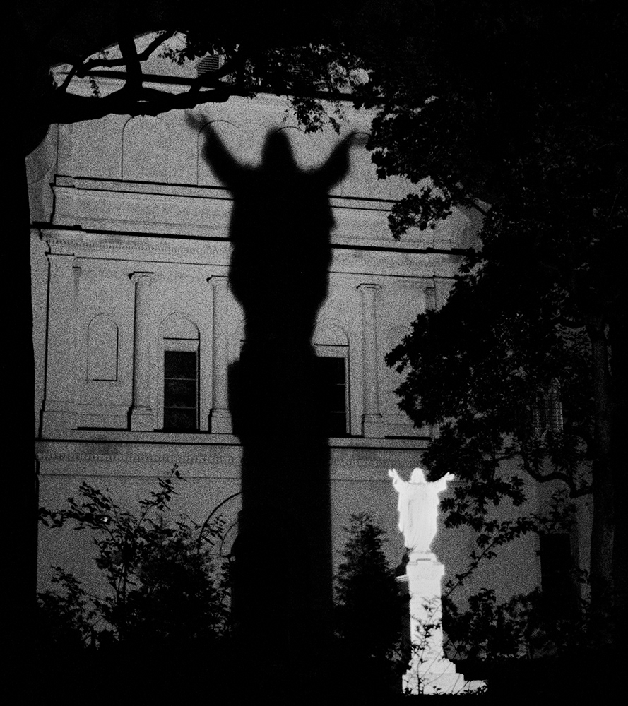 Black and white photograph of the shadow of Jesus on a wall in New Orleans, USA.