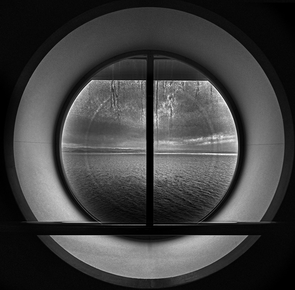 Black and white photograph of a ships bulls eye porthole window