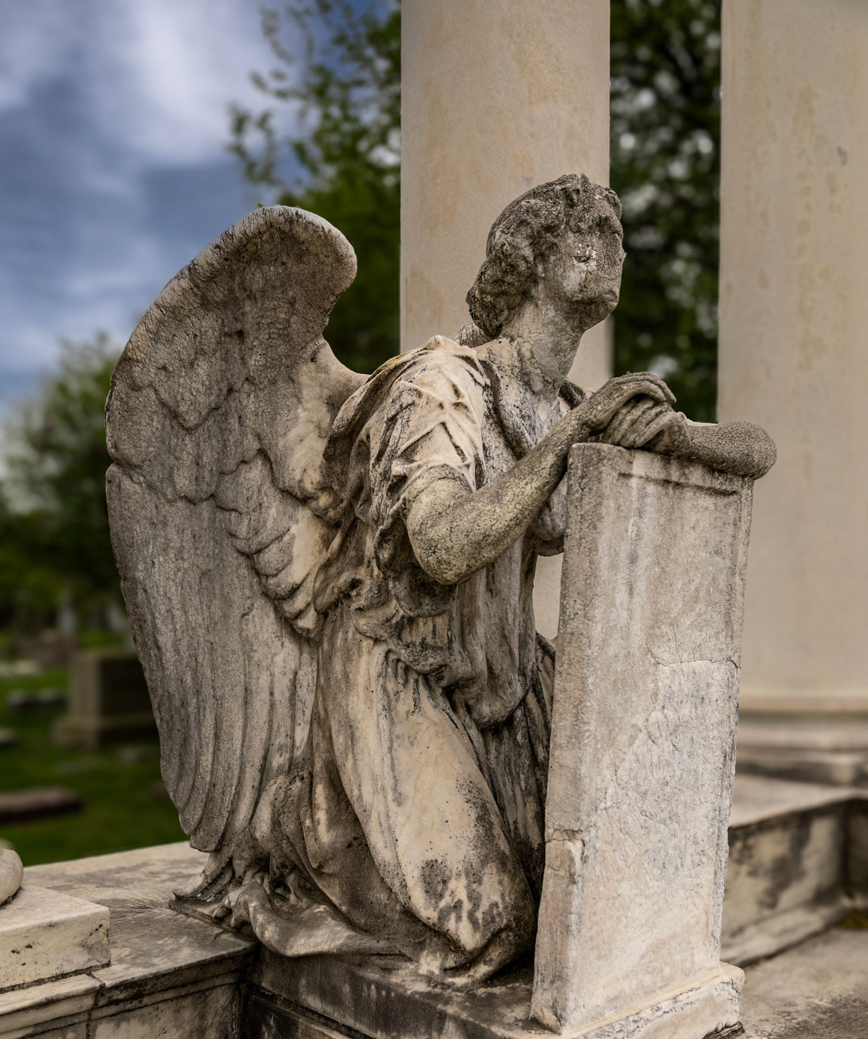 A faceless angel watches over her charge