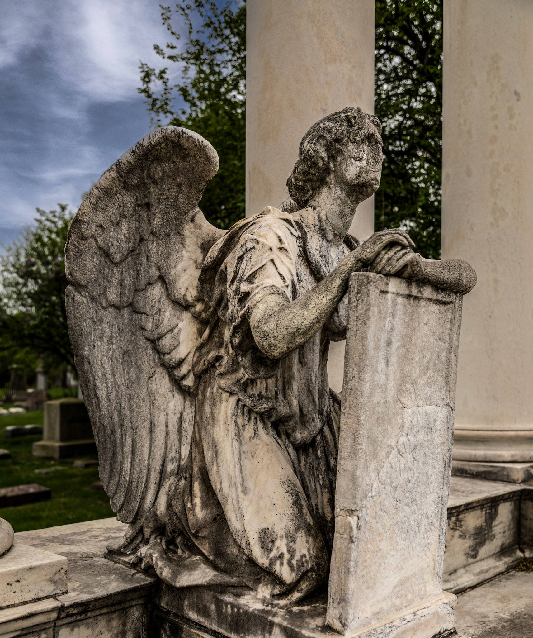 A faceless angel kneels