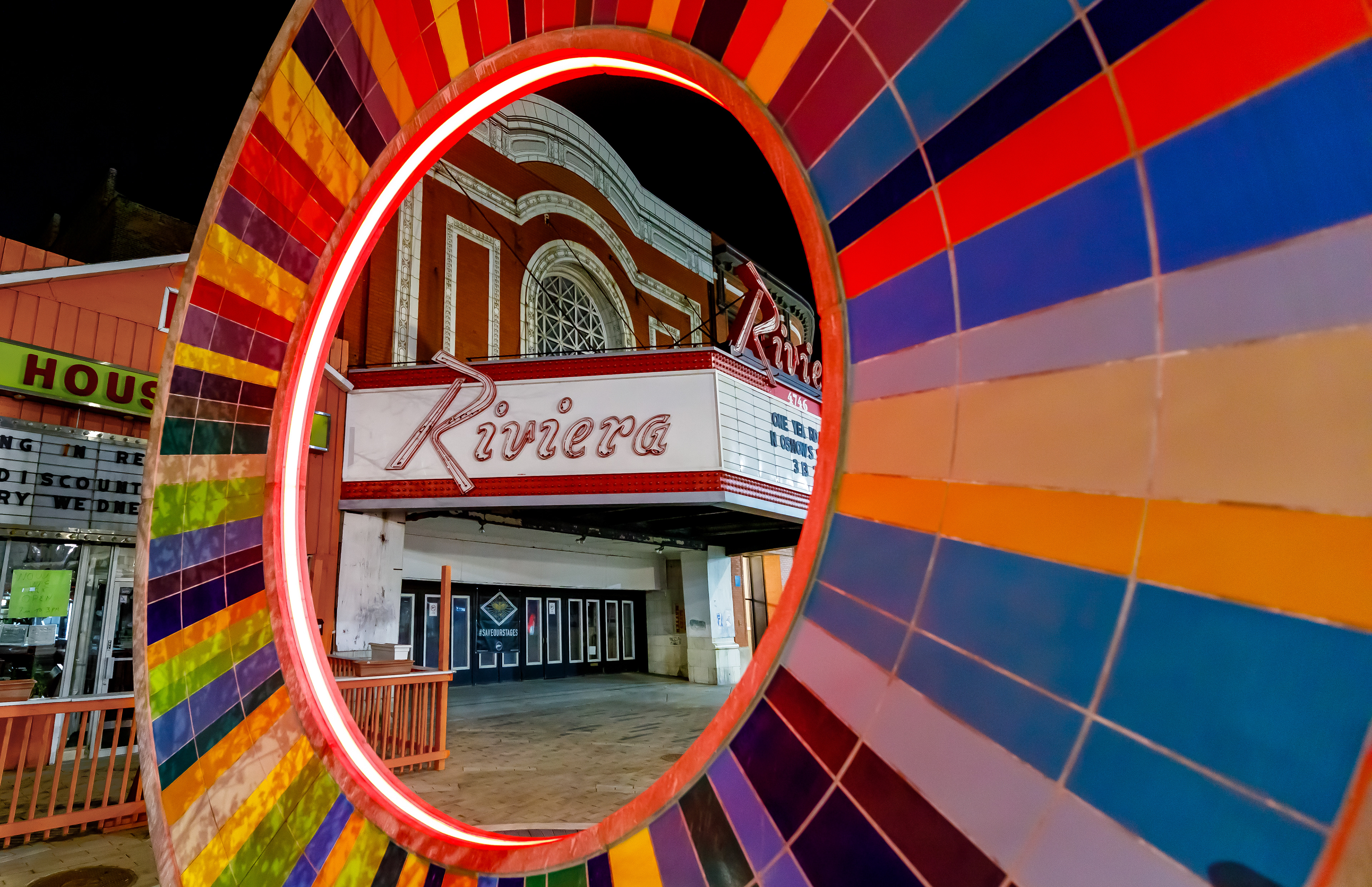 The Riviera Theatre sign seen through a sculpture