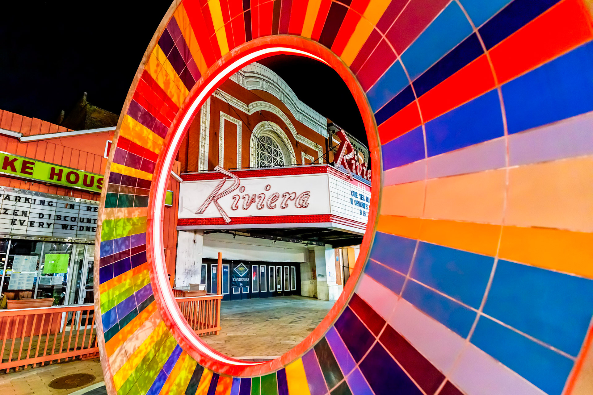 The Riviera Theatre sign seen through a sculpture