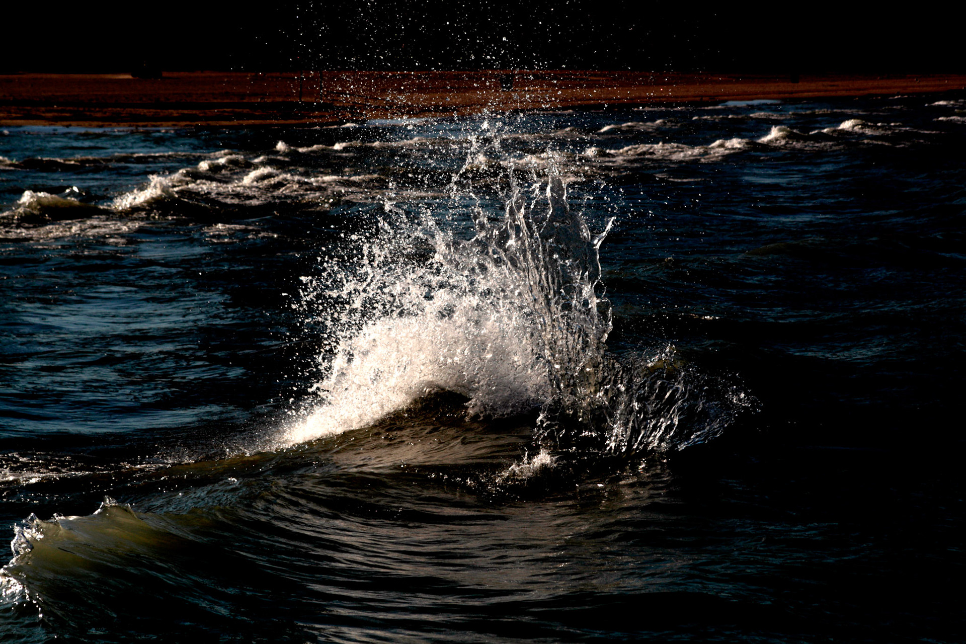 Two waves colliding on Lake Michigan at night