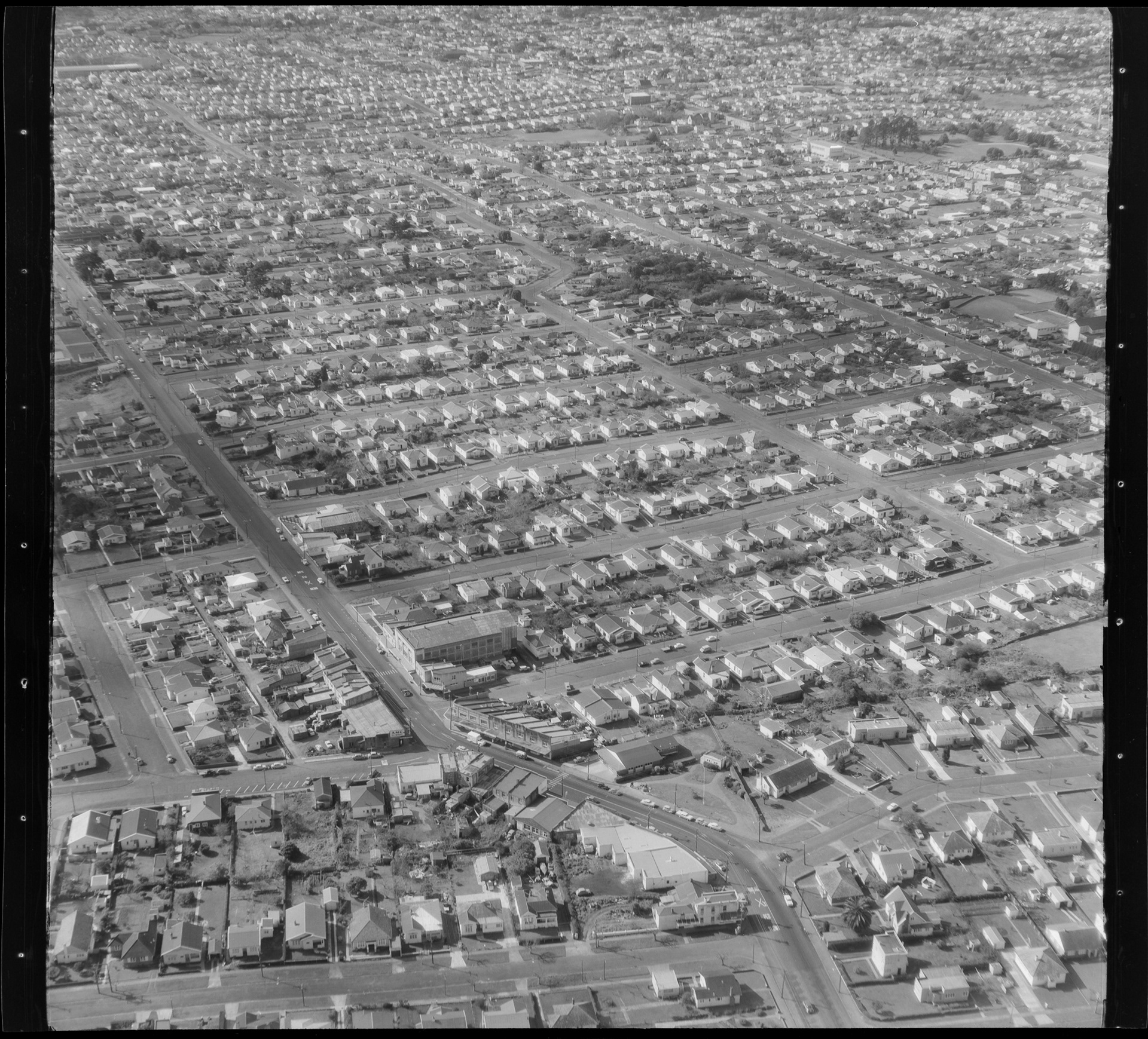 Photograph from the Whites Aviation collection, taken in 1961, showing the Sandringham shops in the foreground. Alexander Turnbull Library WA-55693-F.
