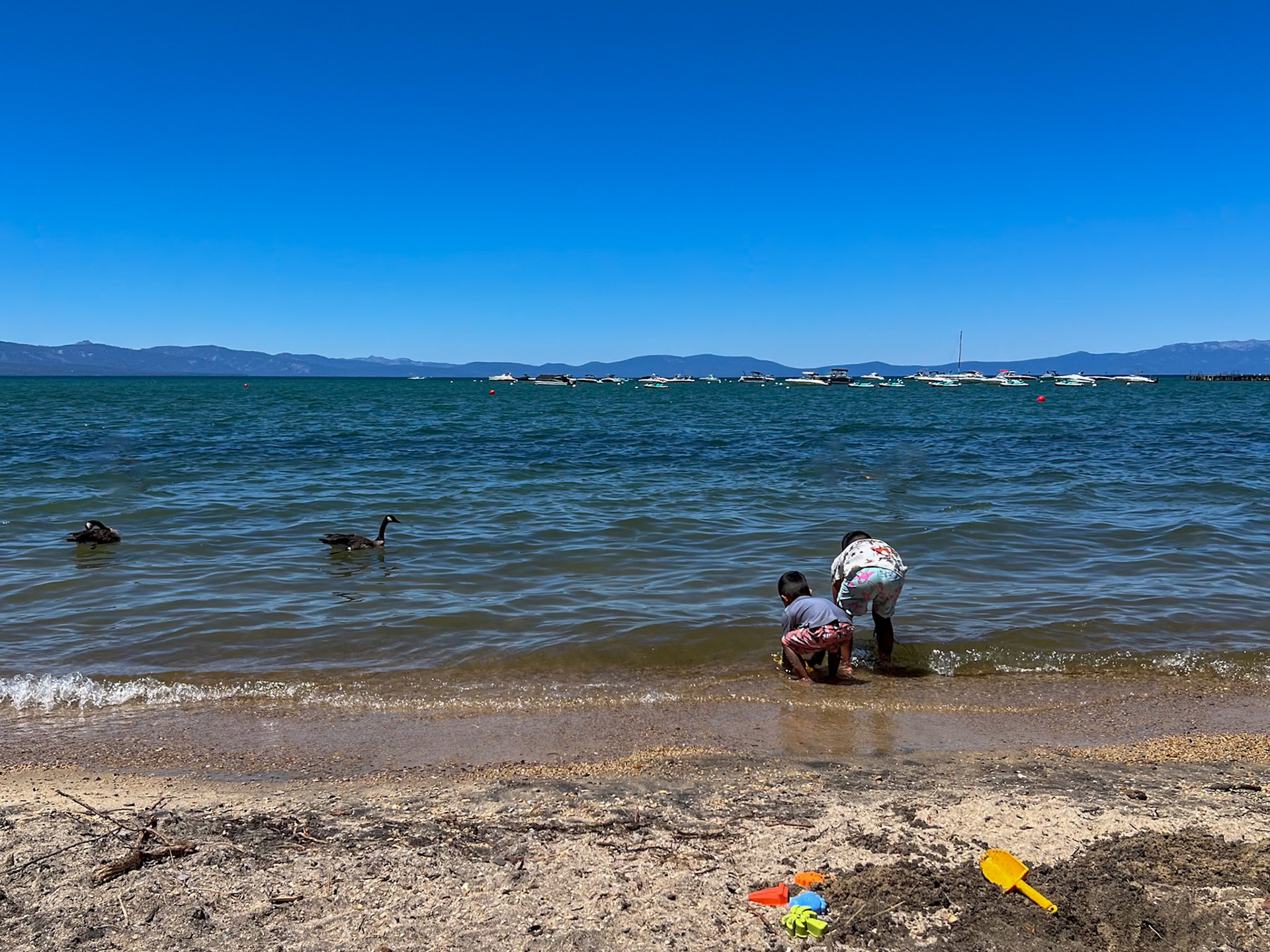 Two boys play on Lake Tahoe beach