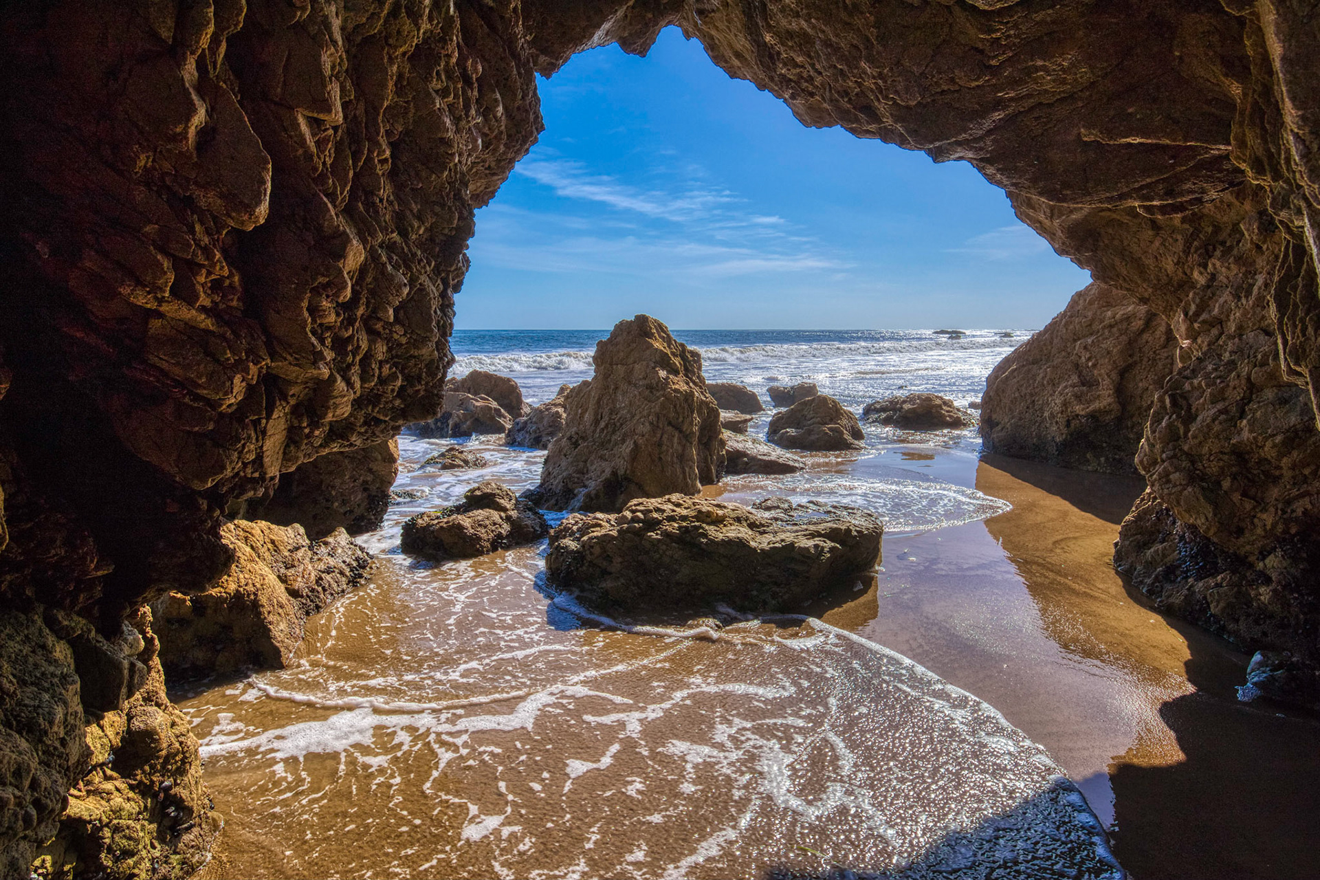 Beautiful rock arch with a view of the ocean at the popular El Matador Beach along the Southern California coast, Malibu, California