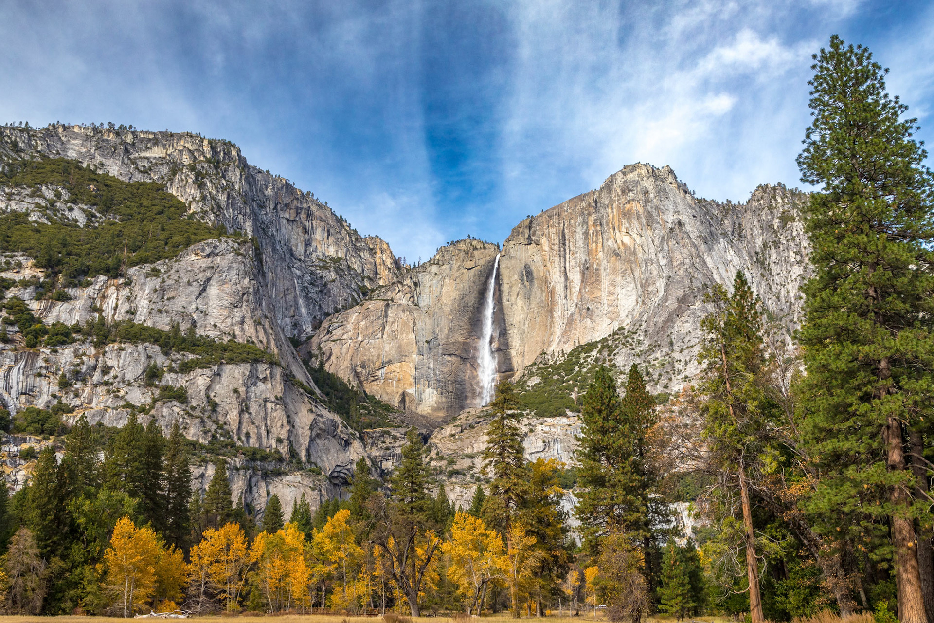 Experience the peacefulness of a hike in Yosemite Valley, surrounded by stunning autumn colors and the majestic Yosemite Falls.