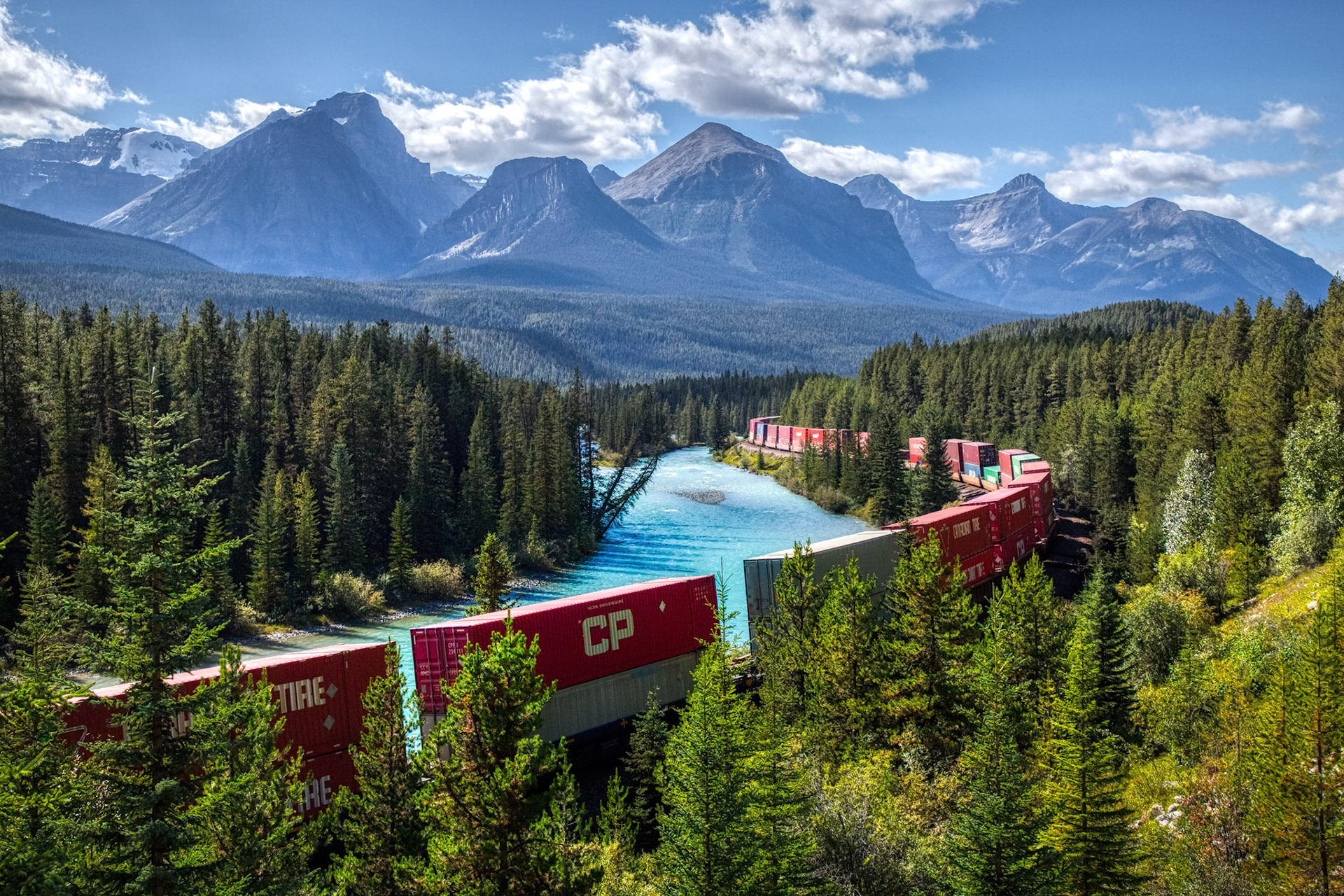 Iconic view of Morants Curve where the Canadian Pacific Railway runs along the stunning Bow River with the beautiful Canadian Rockies in the background, Banff National Park, Alberta, Canada