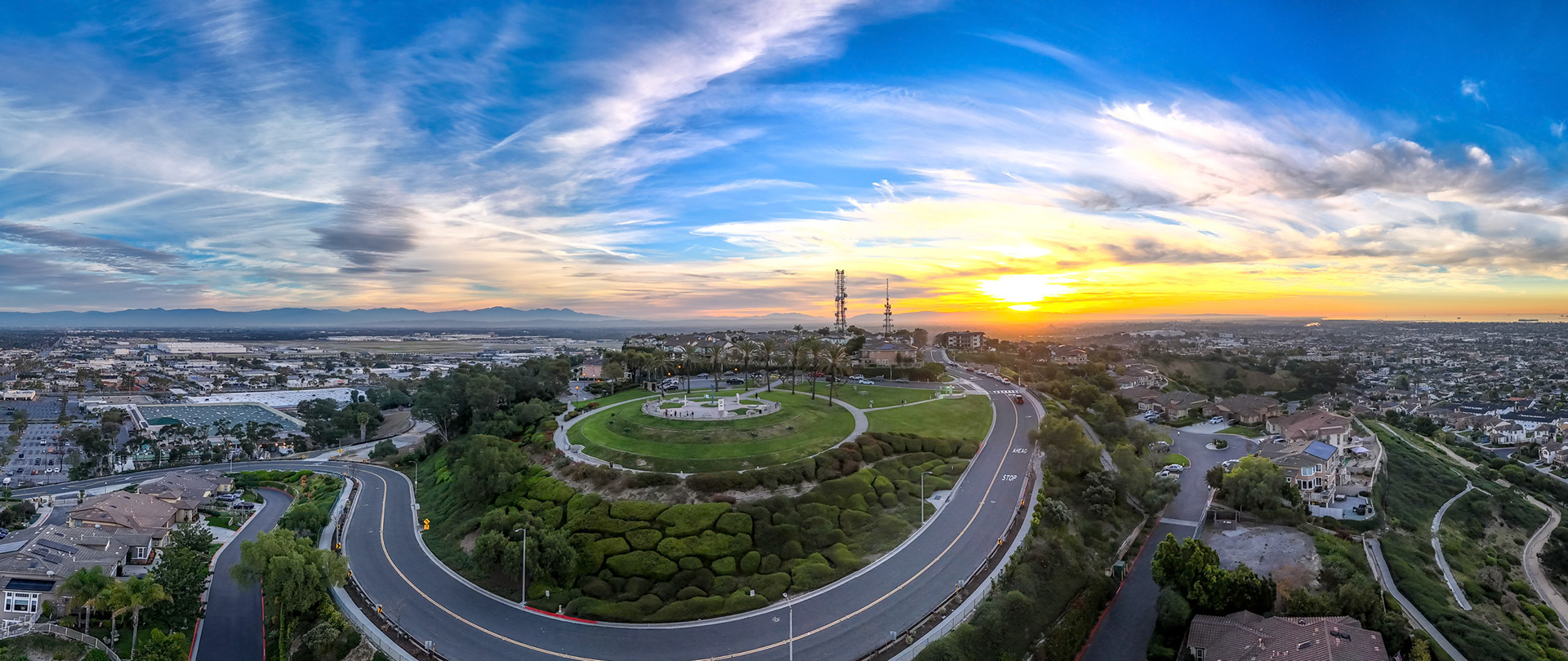 Stunning aerial view of Hilltop Park in Signal Hill, California at sunrise with colorful morning light revealing the landscape