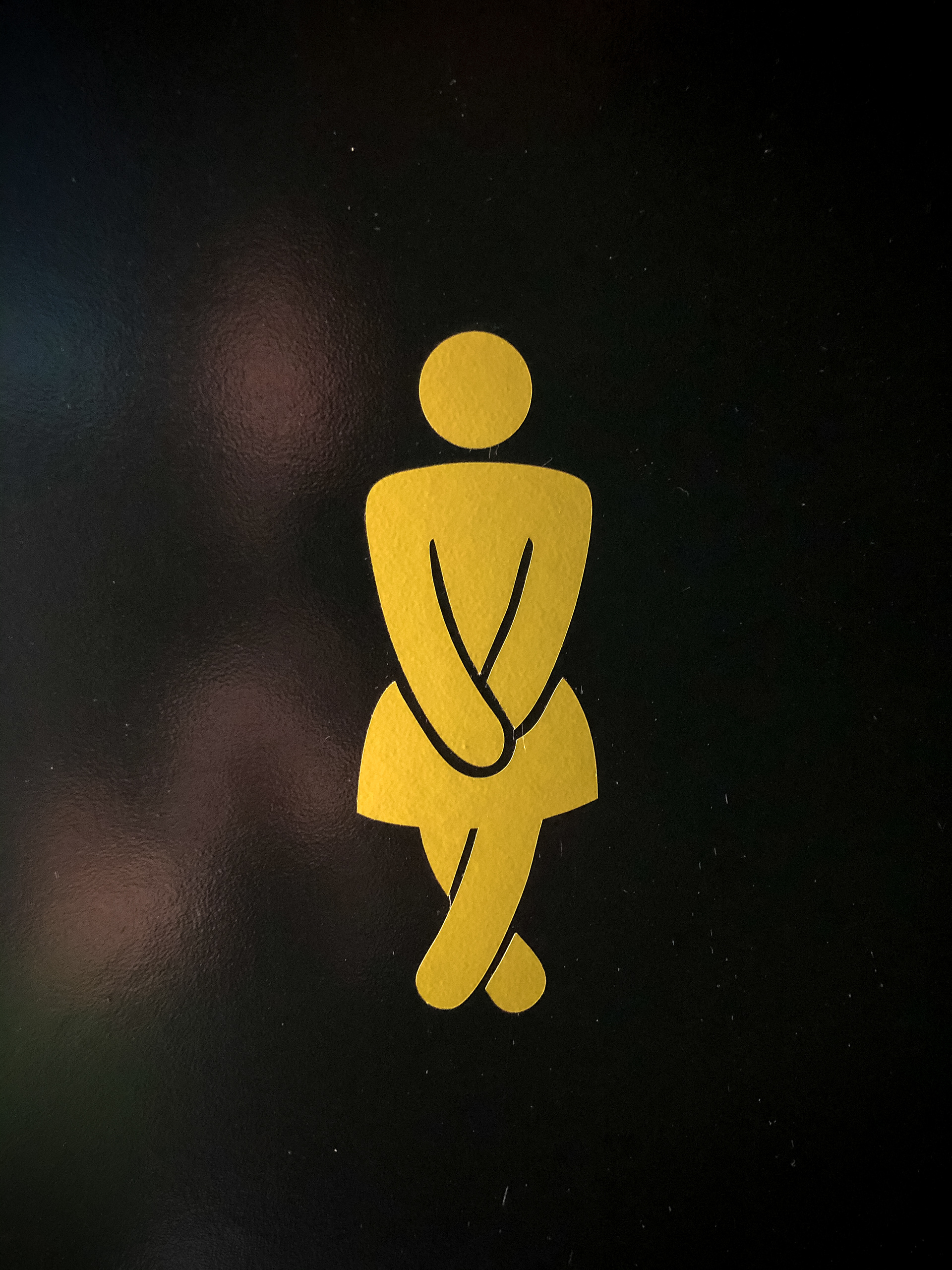 a female bathroom logo crossing his legs busting for the bathroom