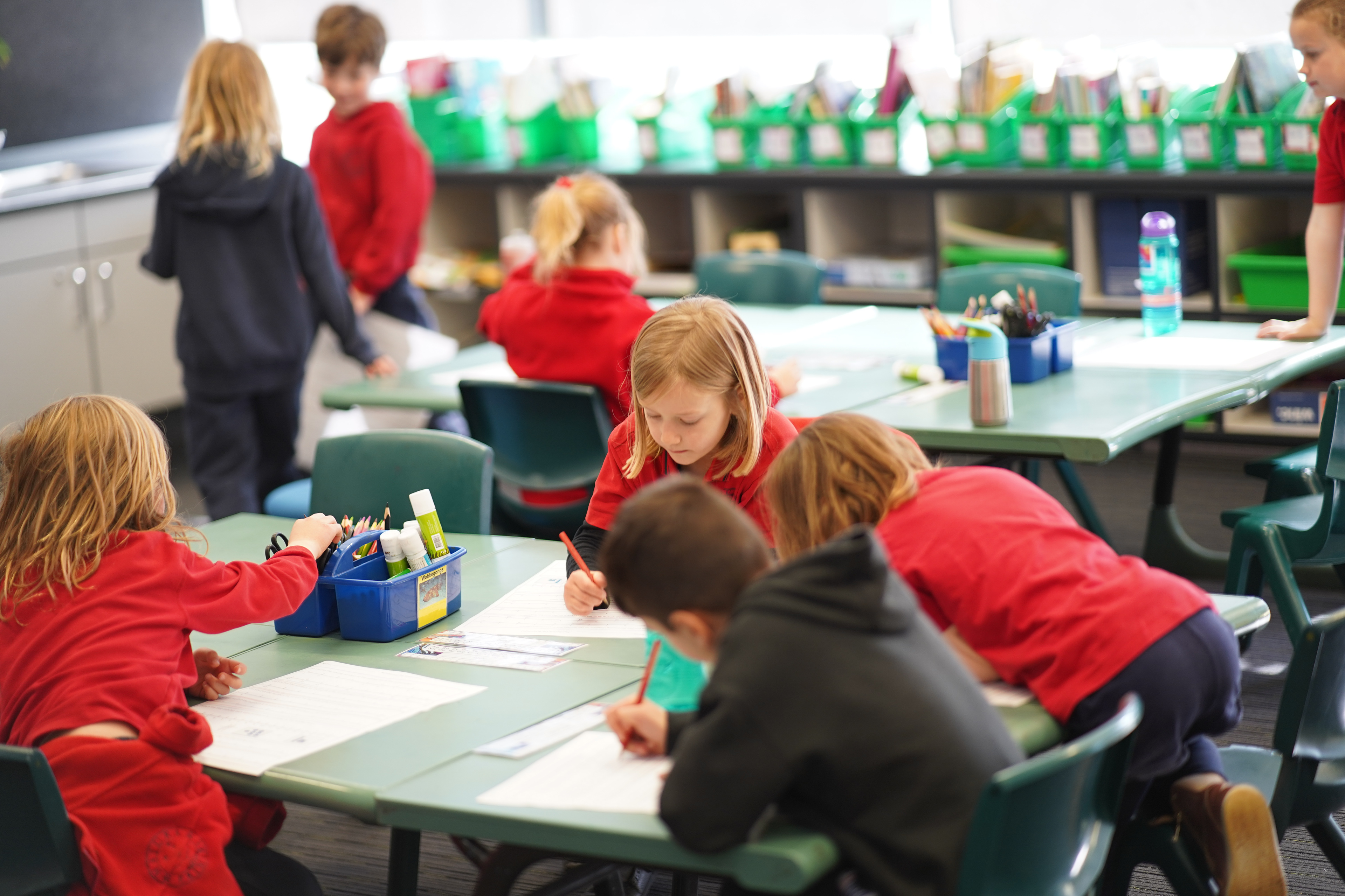 Pre-school students focus on colouring in