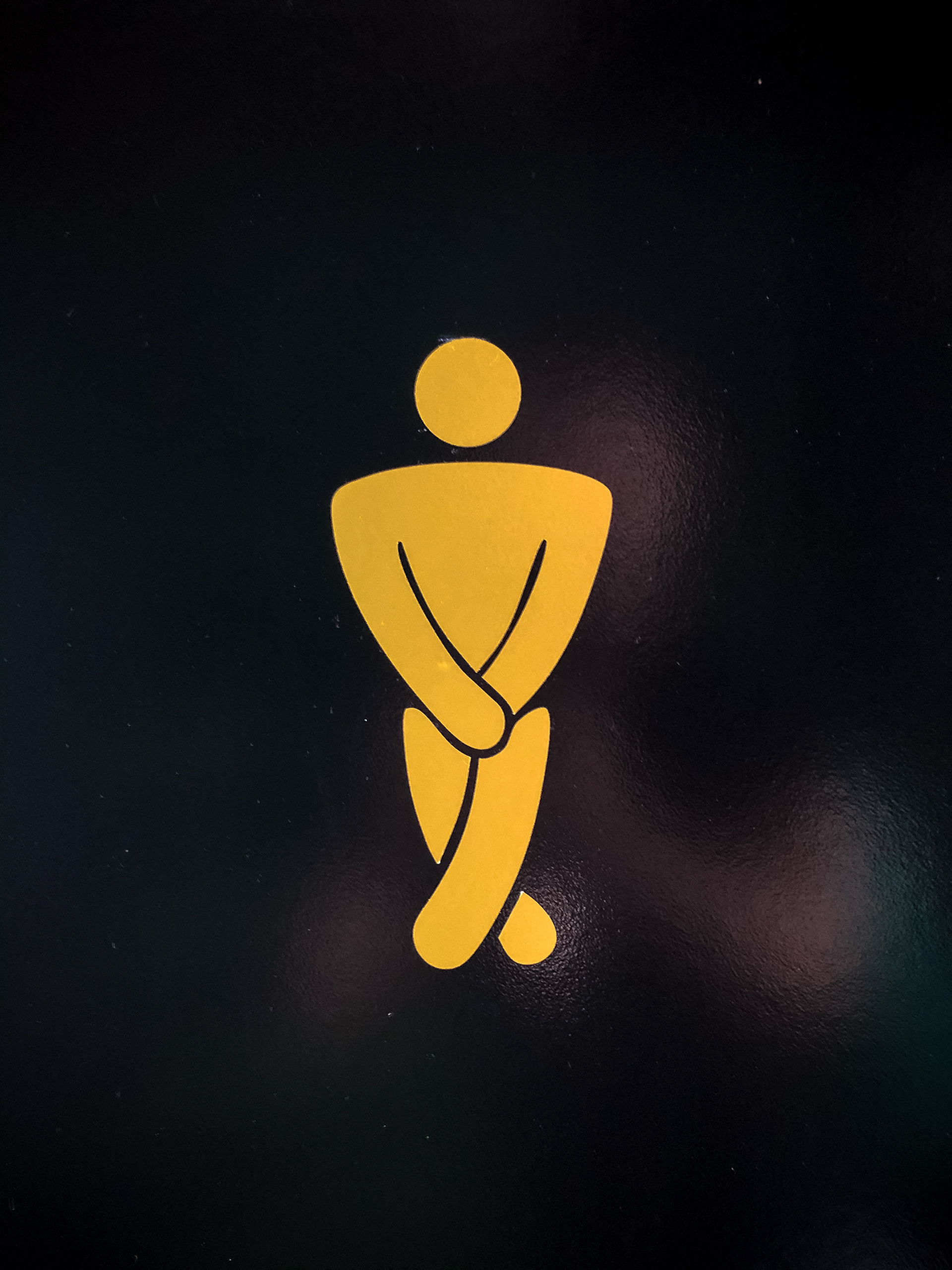 a male bathroom logo crossing his legs busting for the bathroom