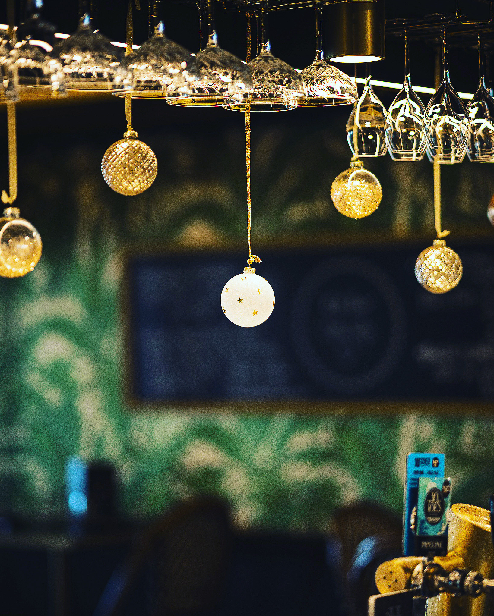 Christmas borbells hanging from the front of a bar