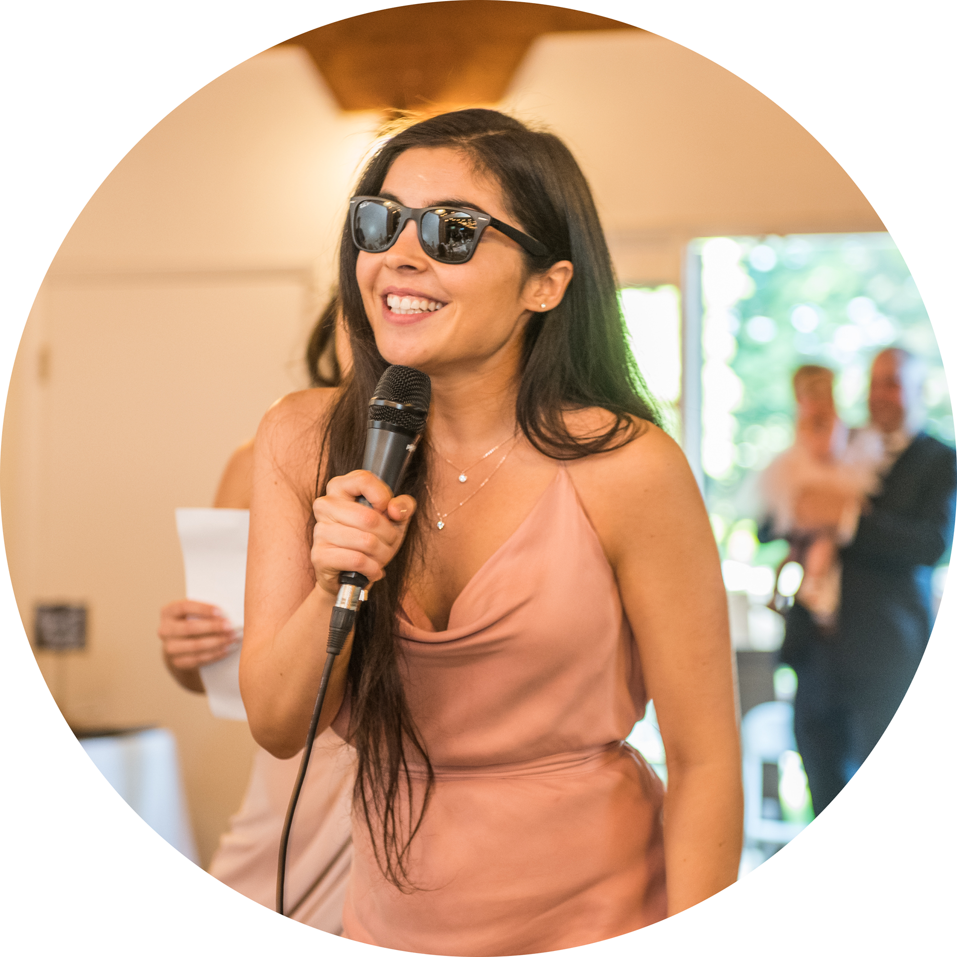 Profile Image of Liliana Sampaio wearing sunglasses and holding a microphone