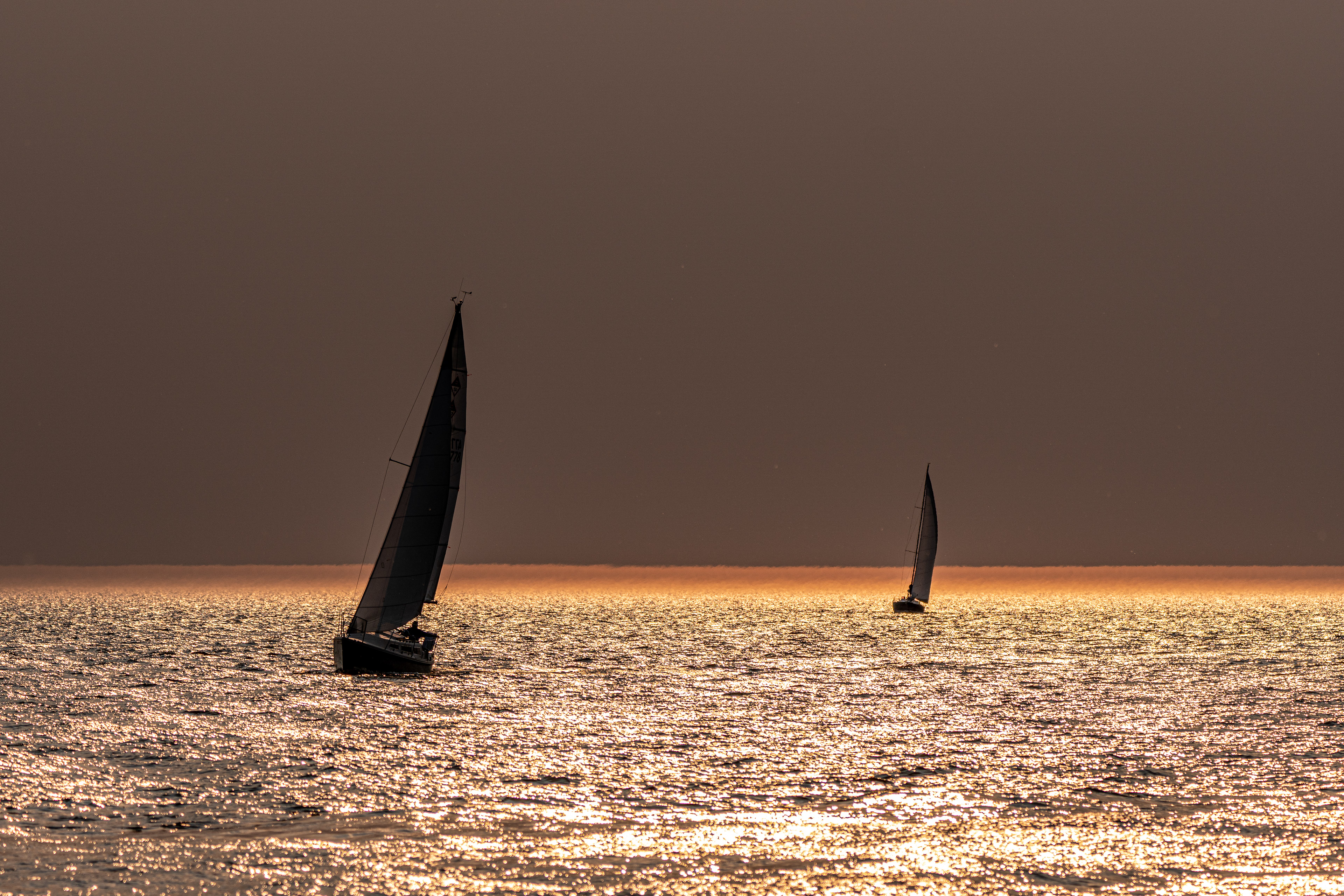 Sailing on Gold: Before sunset in a hazy evening on Lake Michigan (St. Joseph, MI)