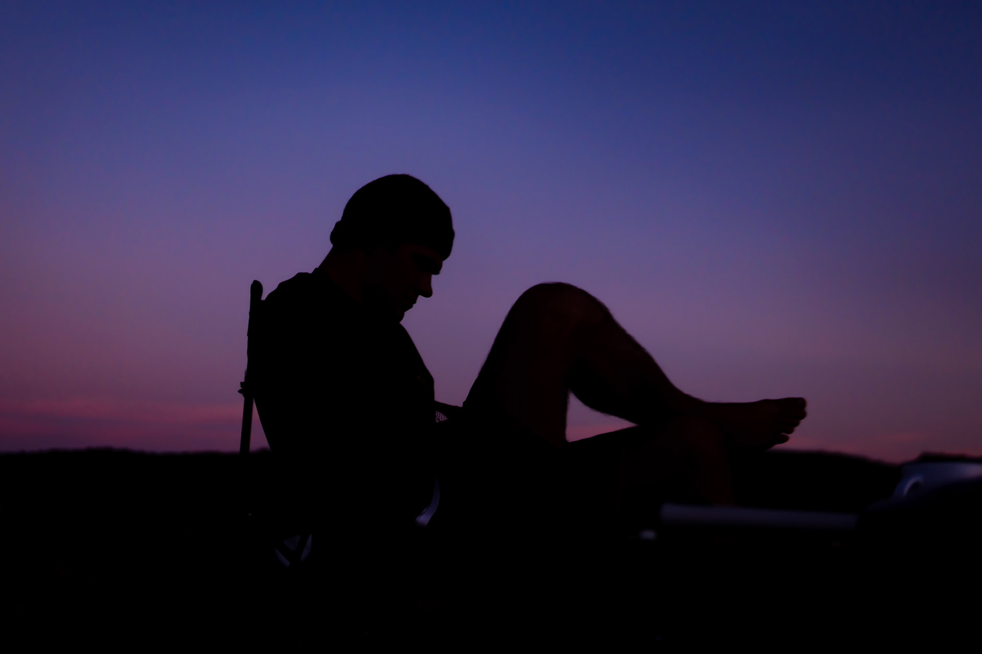 silhouette of a seated man