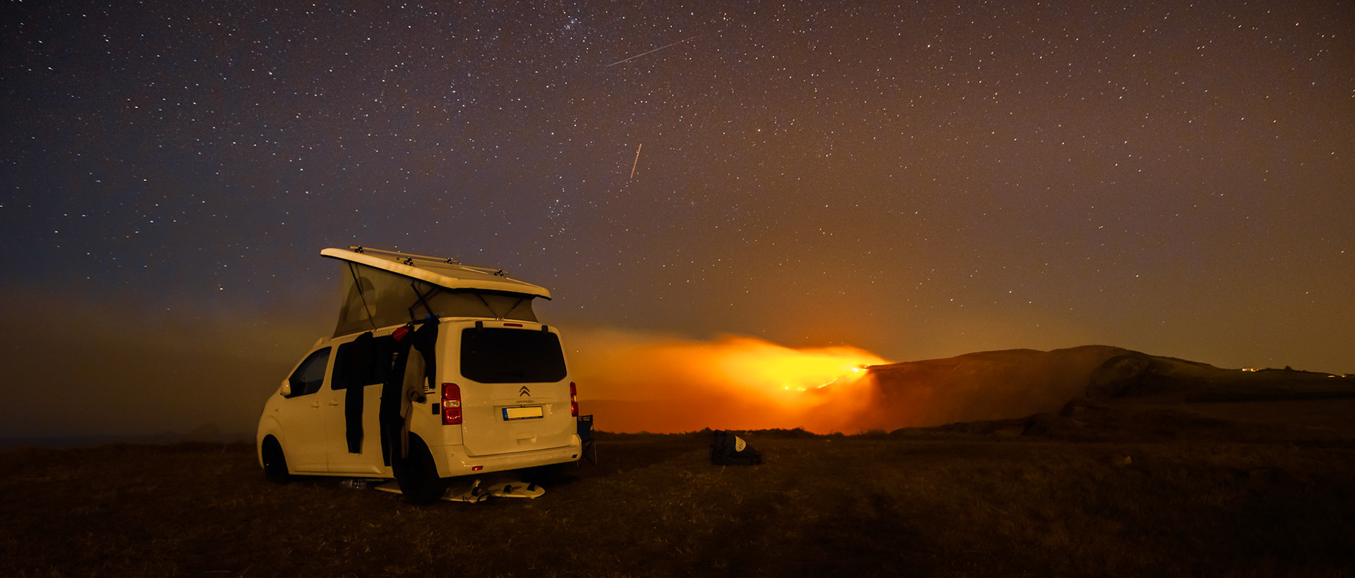 Camping car at night withe stars and fire in background (Citroen Campster)