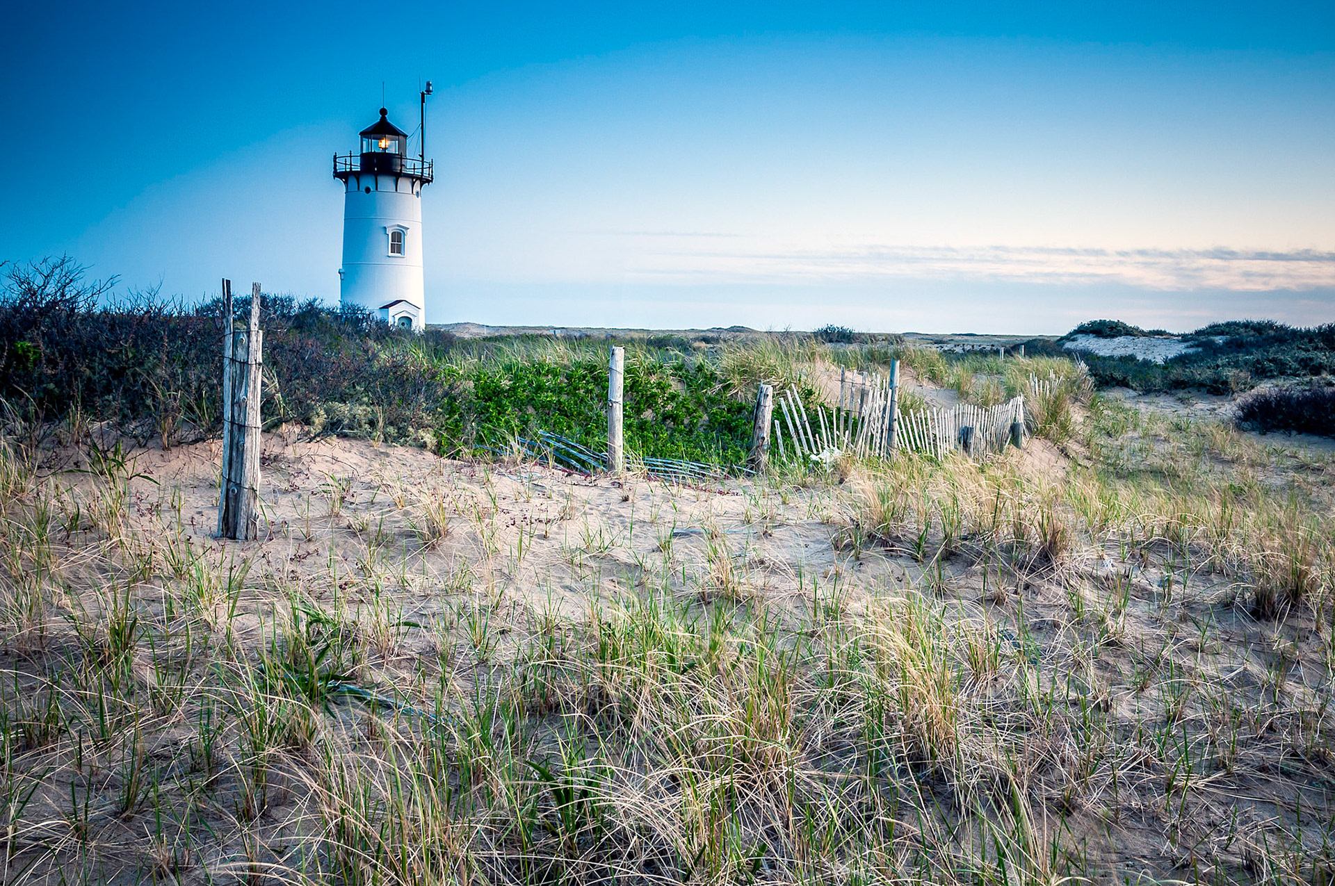 An old broken fence, Drawing a line in the sand, Dunes surround the light
