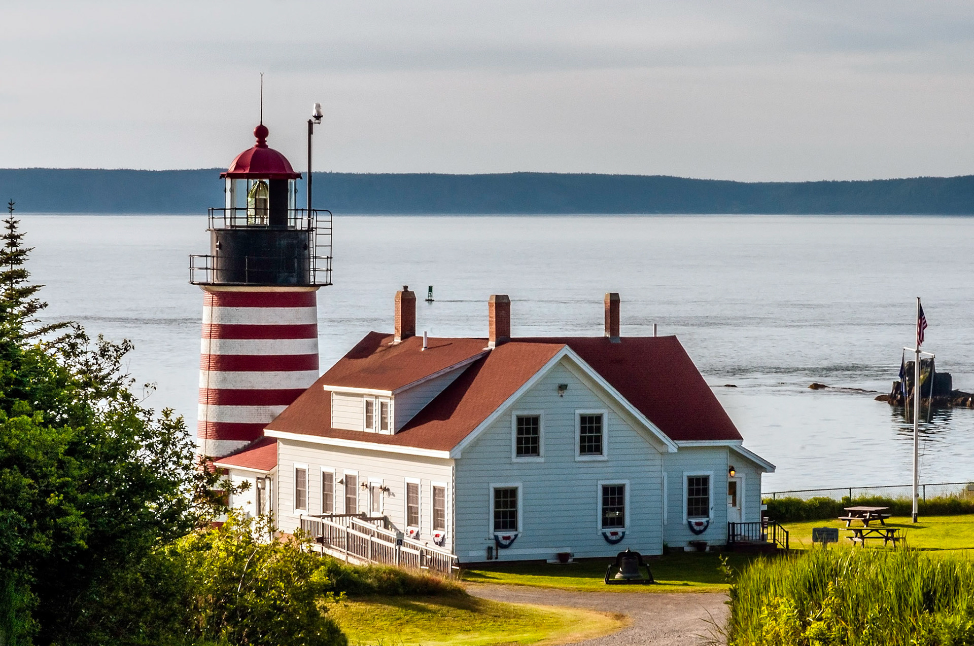 Calm summer morning, Warm air still with ocean's smell, A lighthouse appears
