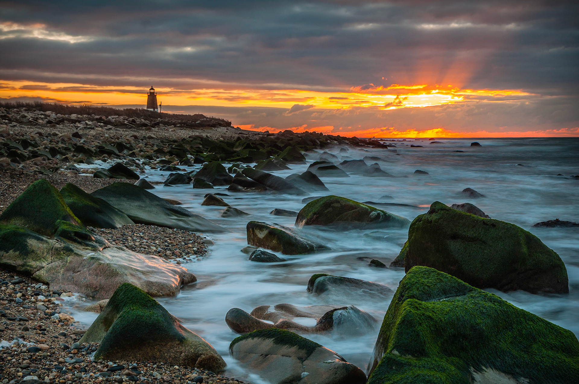 The wind blows harder, As waves crash against the rocks, The lighthouse stands strong