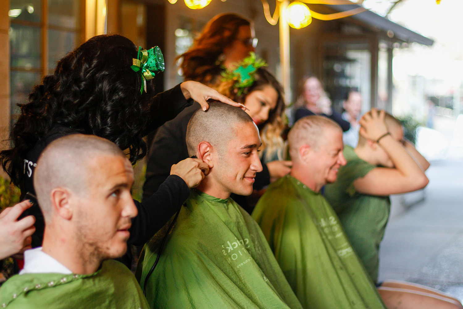 Community members shave their heads at de Vere’s Irish Pub in downtown Davis for "MaHellYeah," raising funds for the St. Baldrick's Foundation in honor of Mahalia White, UC Davis’ freshman outside hitter, on March 8th, 2018.