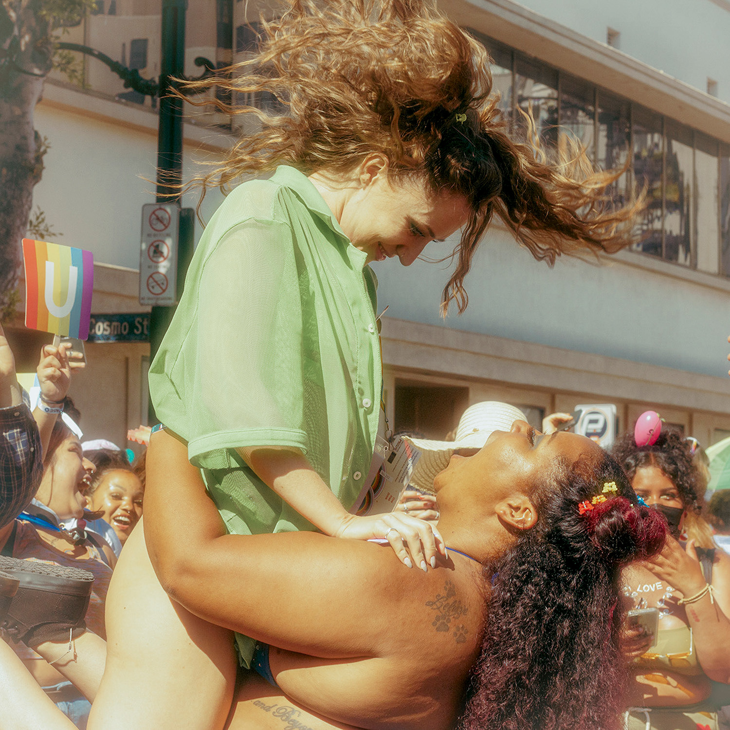 A queer couple joyously took to the dance floor at the West Hollywood Pride Street Fair on June 5th, 2022.