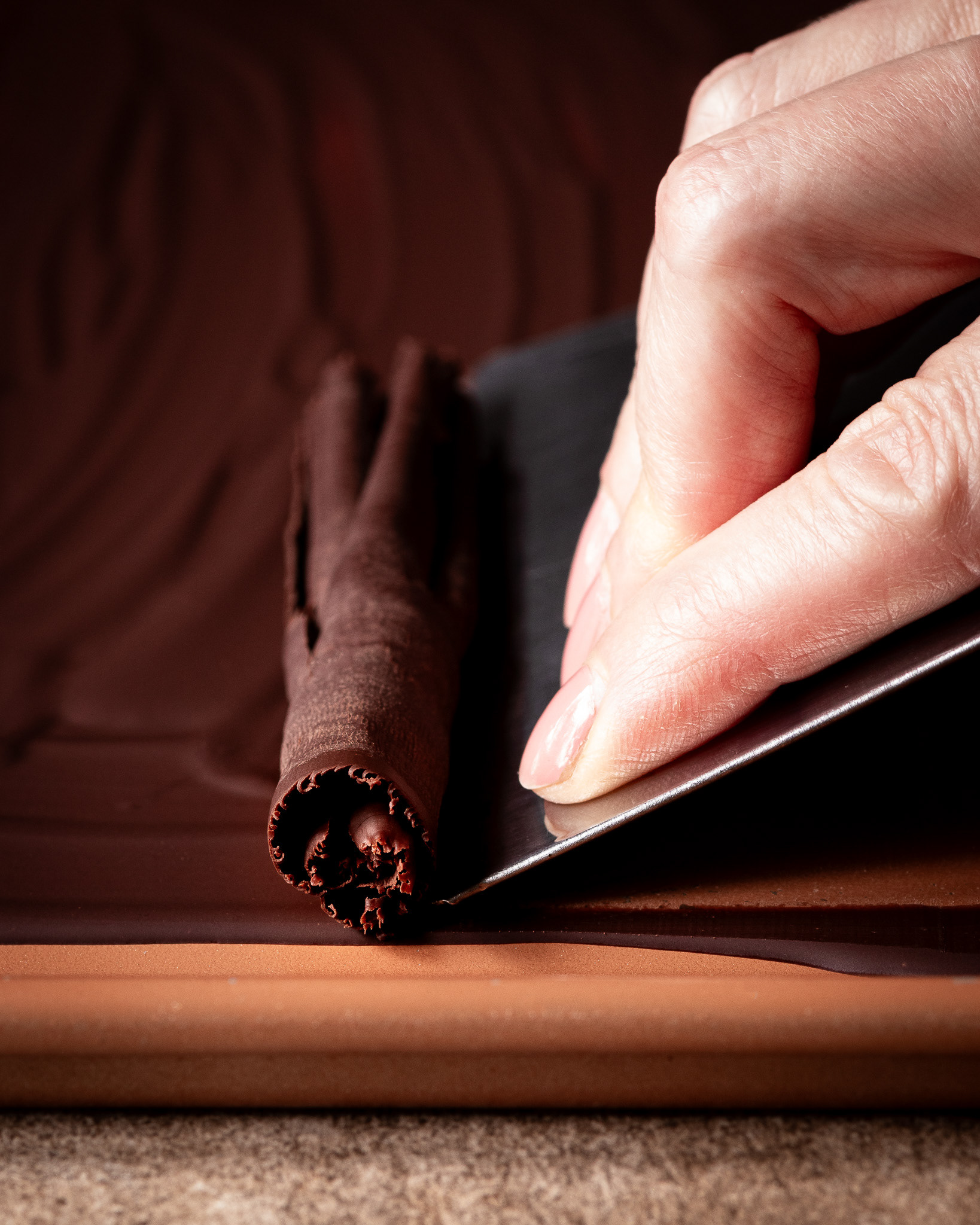Rolling chocolate curls process shot by Nina Bolders Food Photography 