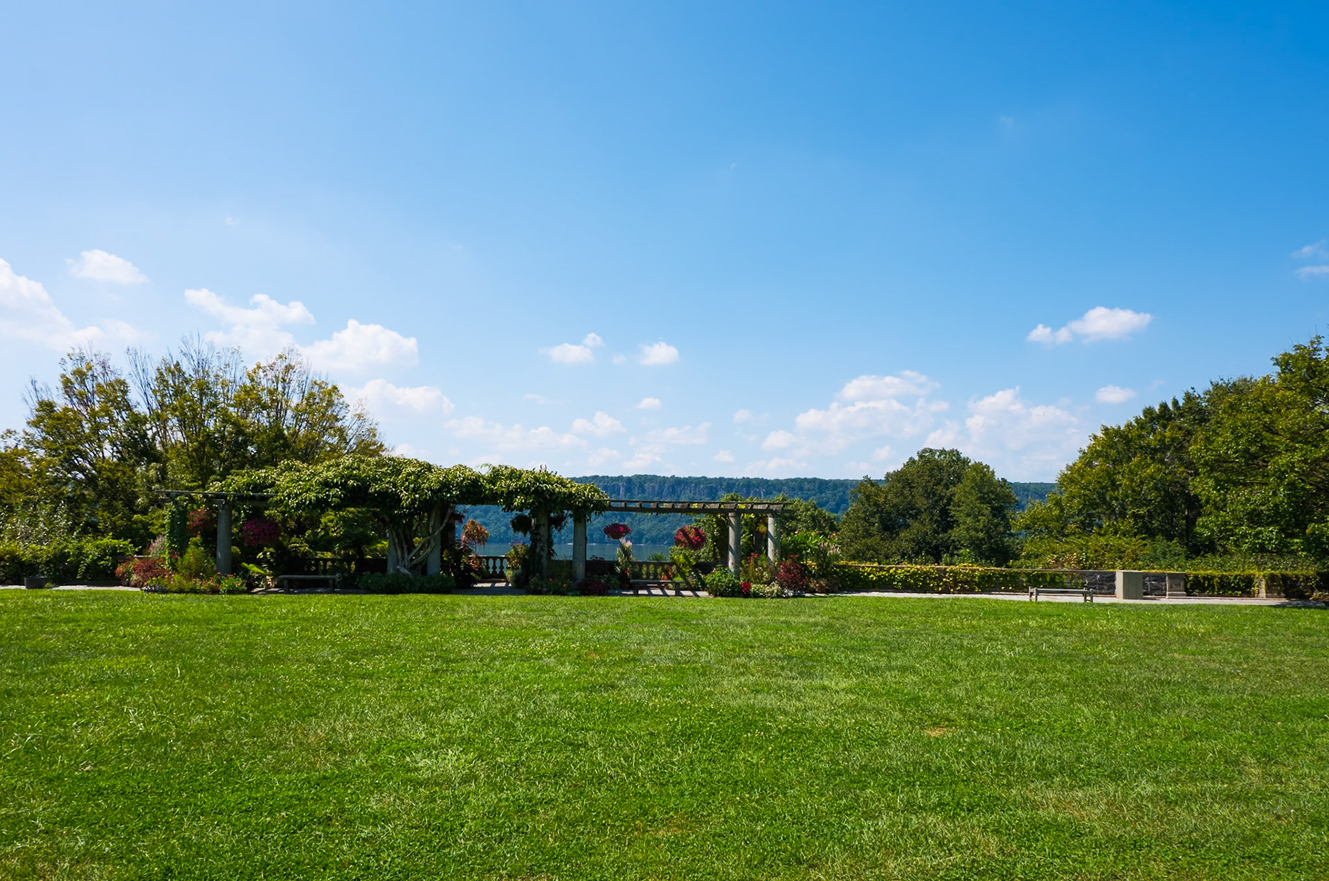 View of Overlook Lawn Trelllis with Hanging Plants and Palisades from Wave Hill August 2024
