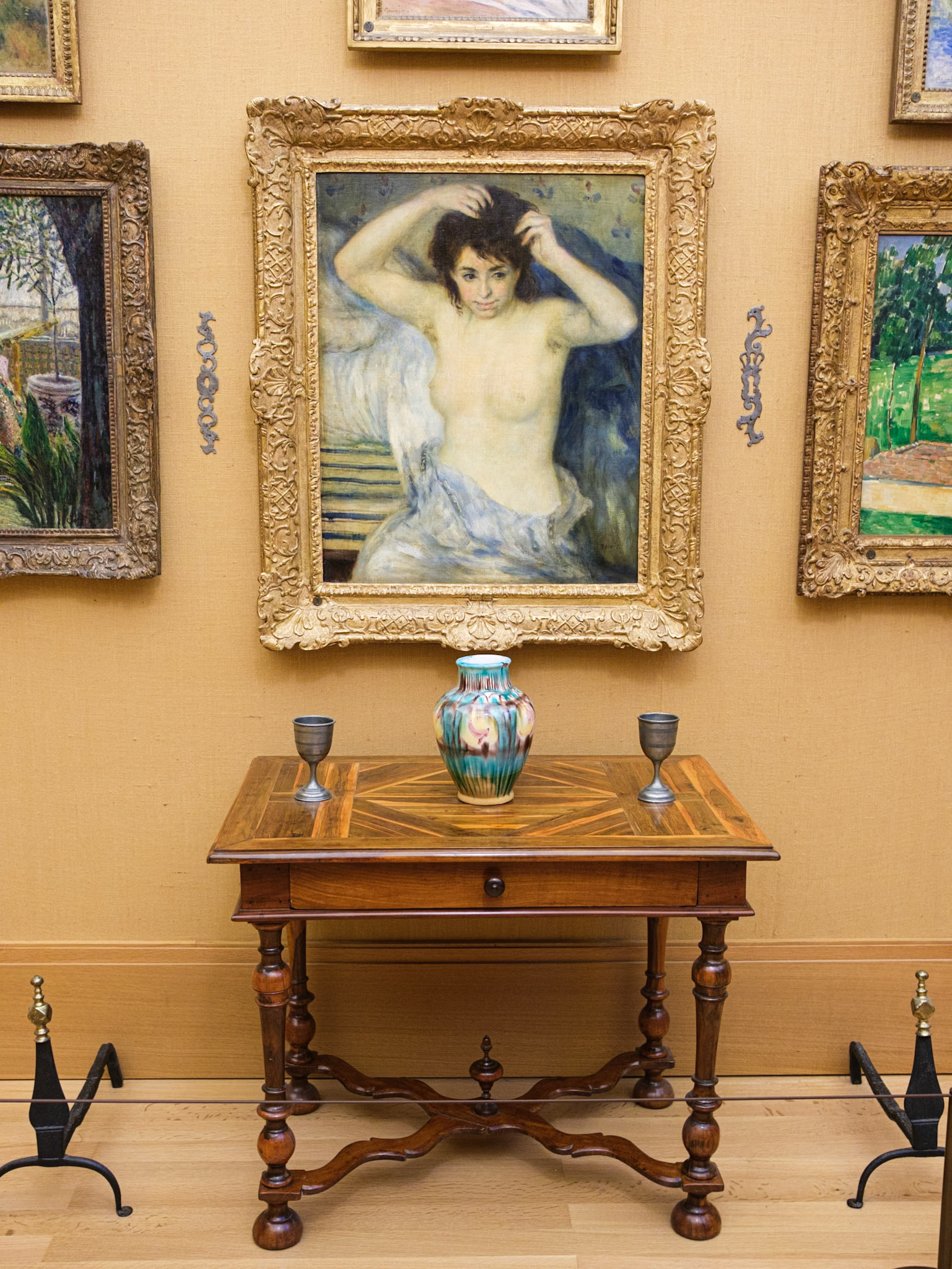 Woman Fixing Hair by Renoir and Table with Vase