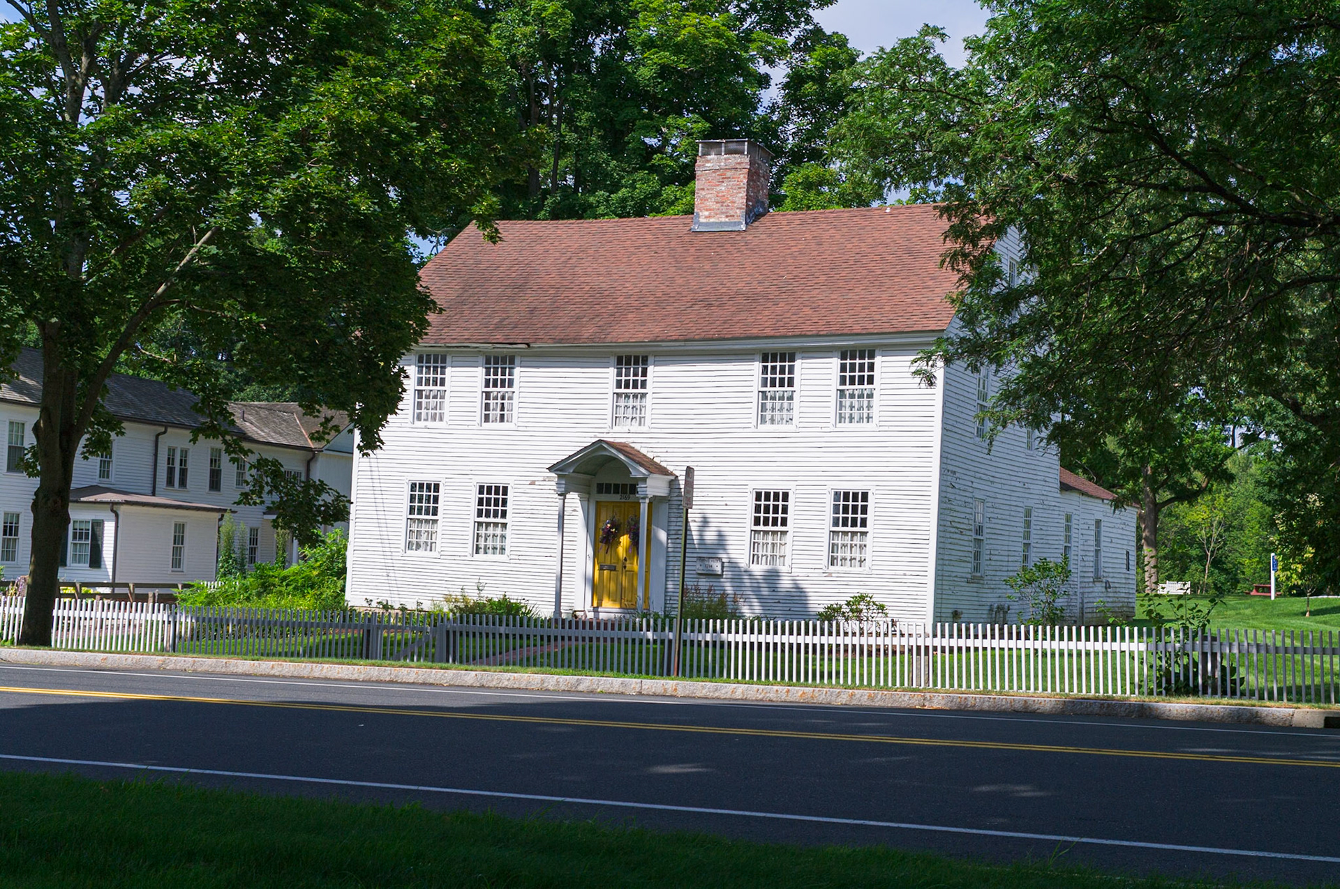 Old White House with Yellow Door on Main Street Glastonbury