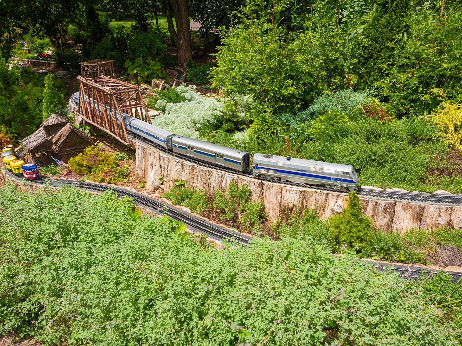 Model Trains with Amtrak Passenger Train Crossing Bridge Morris Arboretum August 2024