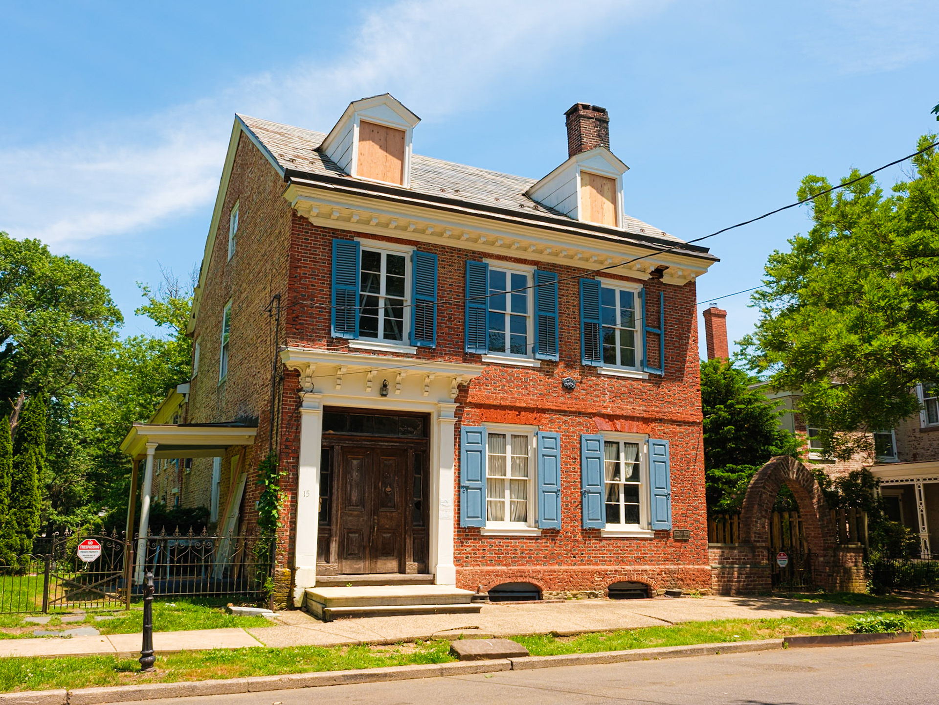Old Brick House With Boarded Dormer Windows in Bordentown May 2024