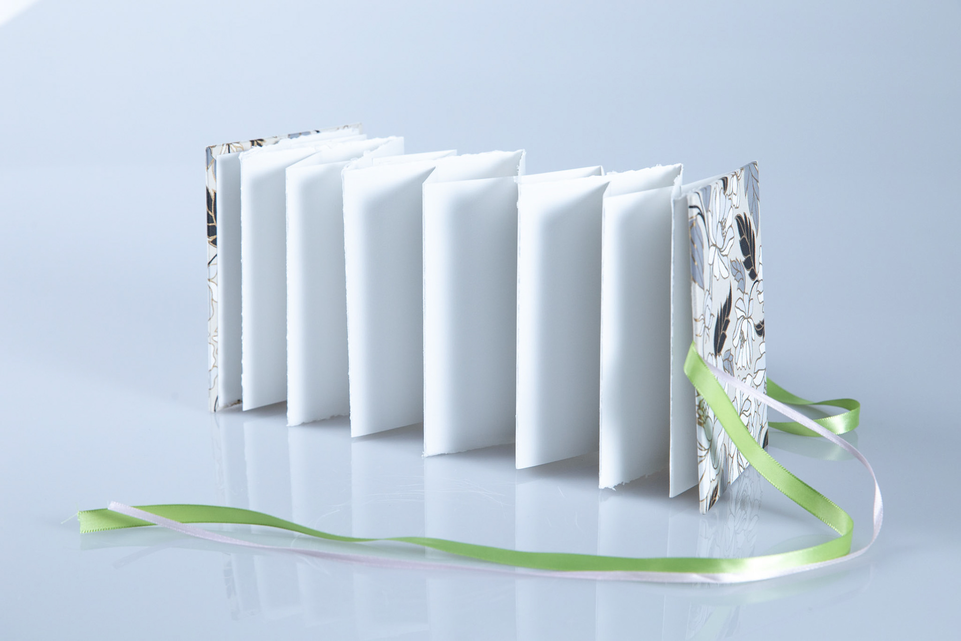 Slotted Accordion, paper, binders board, ribbon, 5 x4 inches