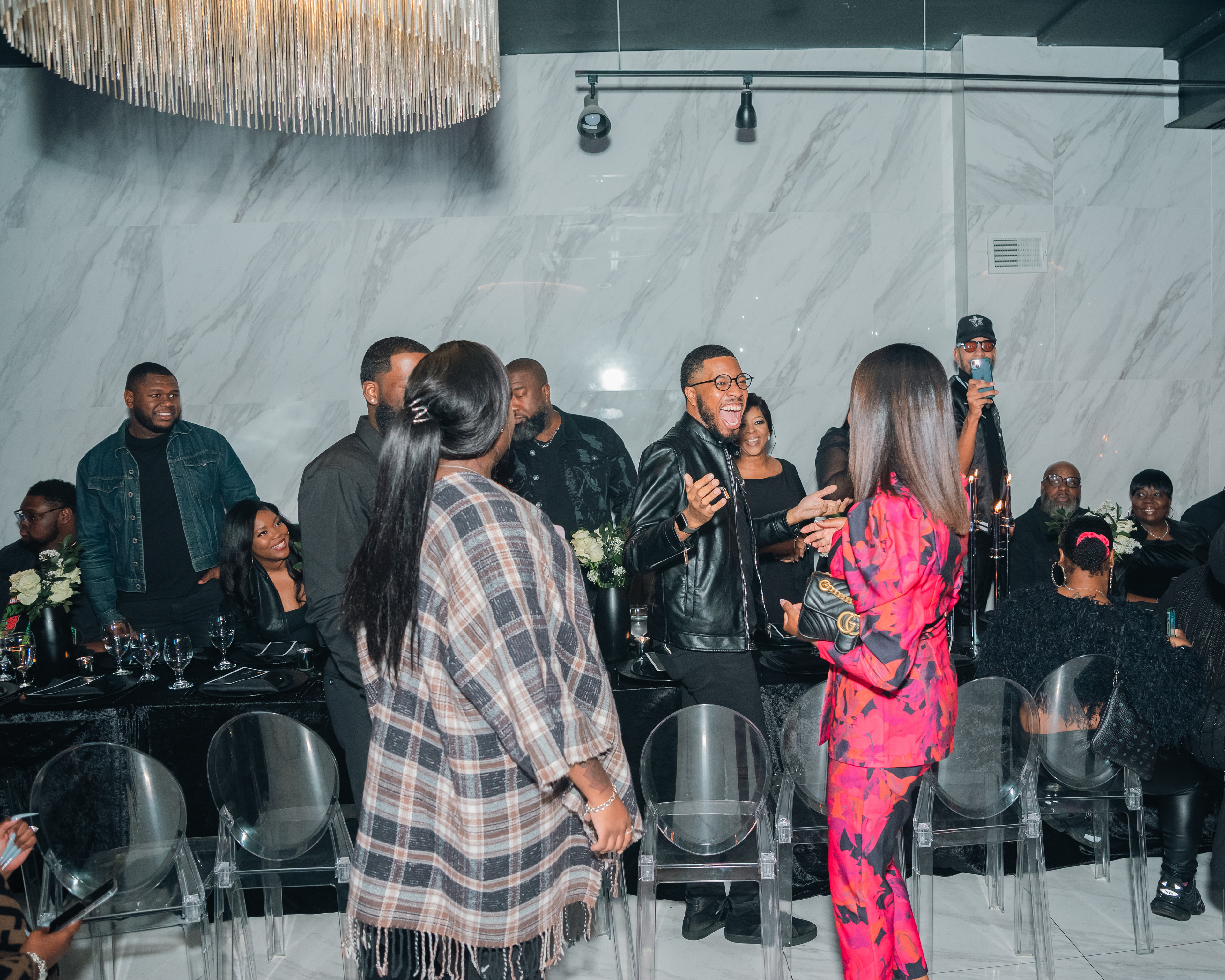 Candid event photography image of guests mingling during a social gathering.