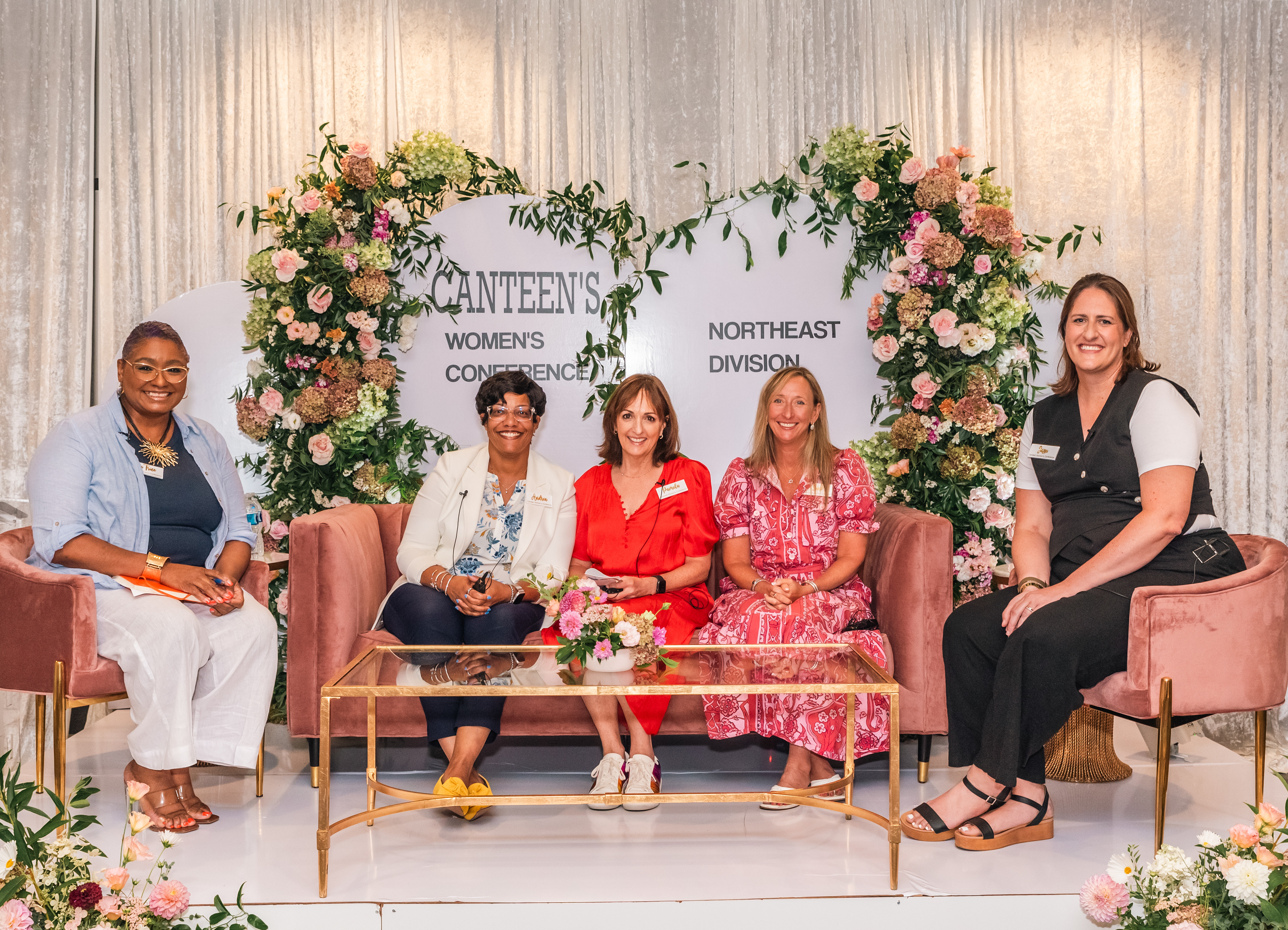 Event photo of panelists seated on stage during a hosted discussion.