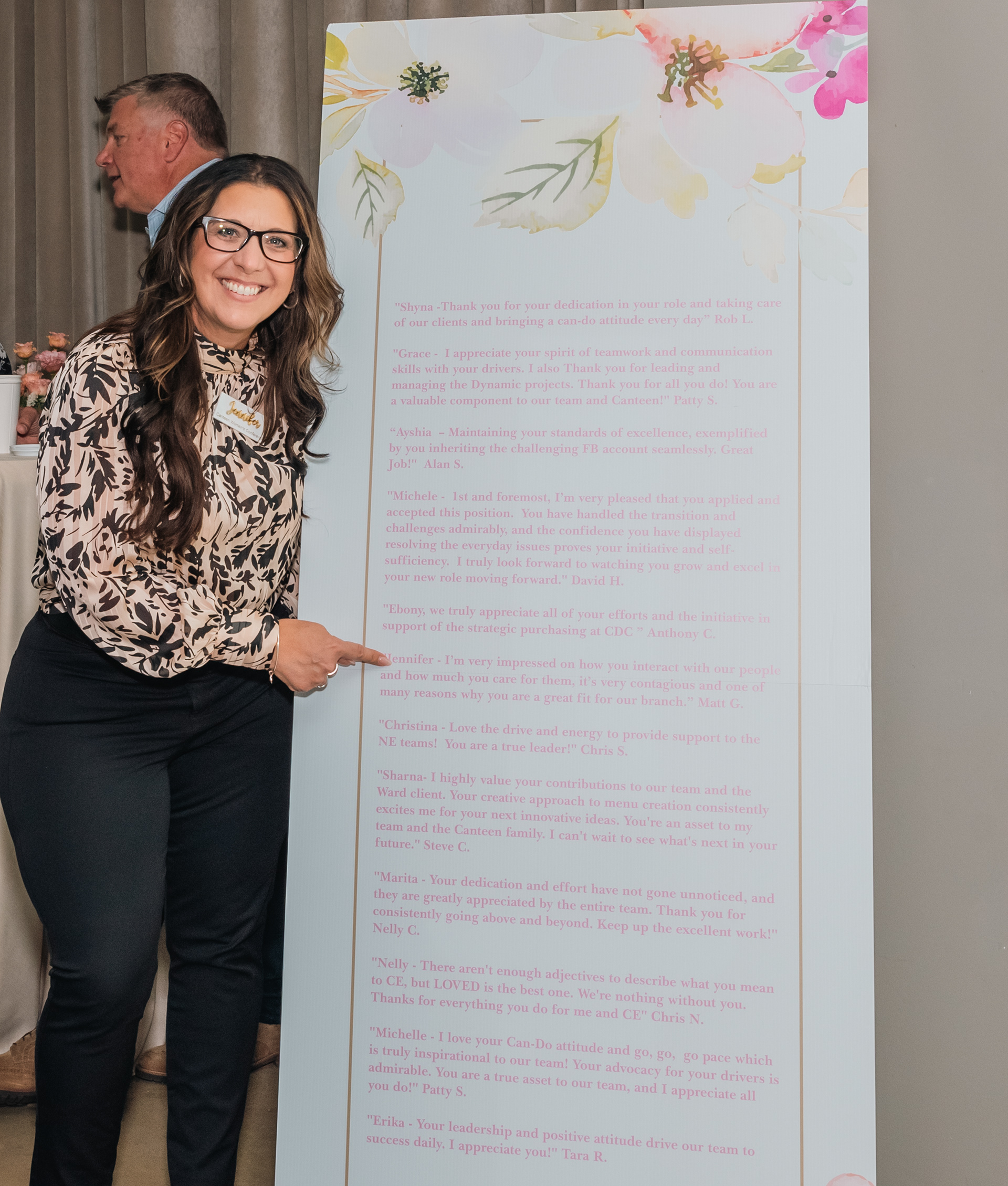 Event photography image of a guest standing beside an informational display.