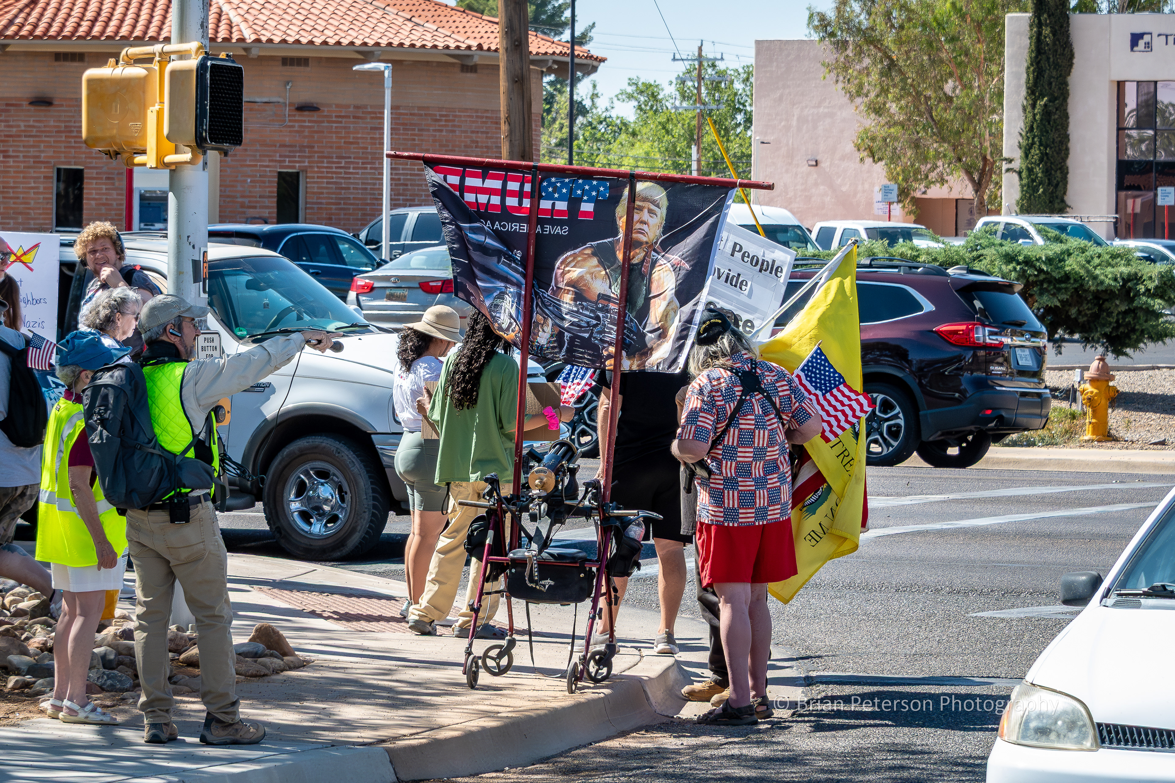 Counter-protester, old guy with a pistol in a shoulder holster. Magnify the photo and see what appears to be a Gatling gun mounted on his walker.
