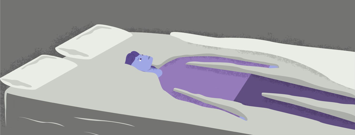 A woman sinking into a bed