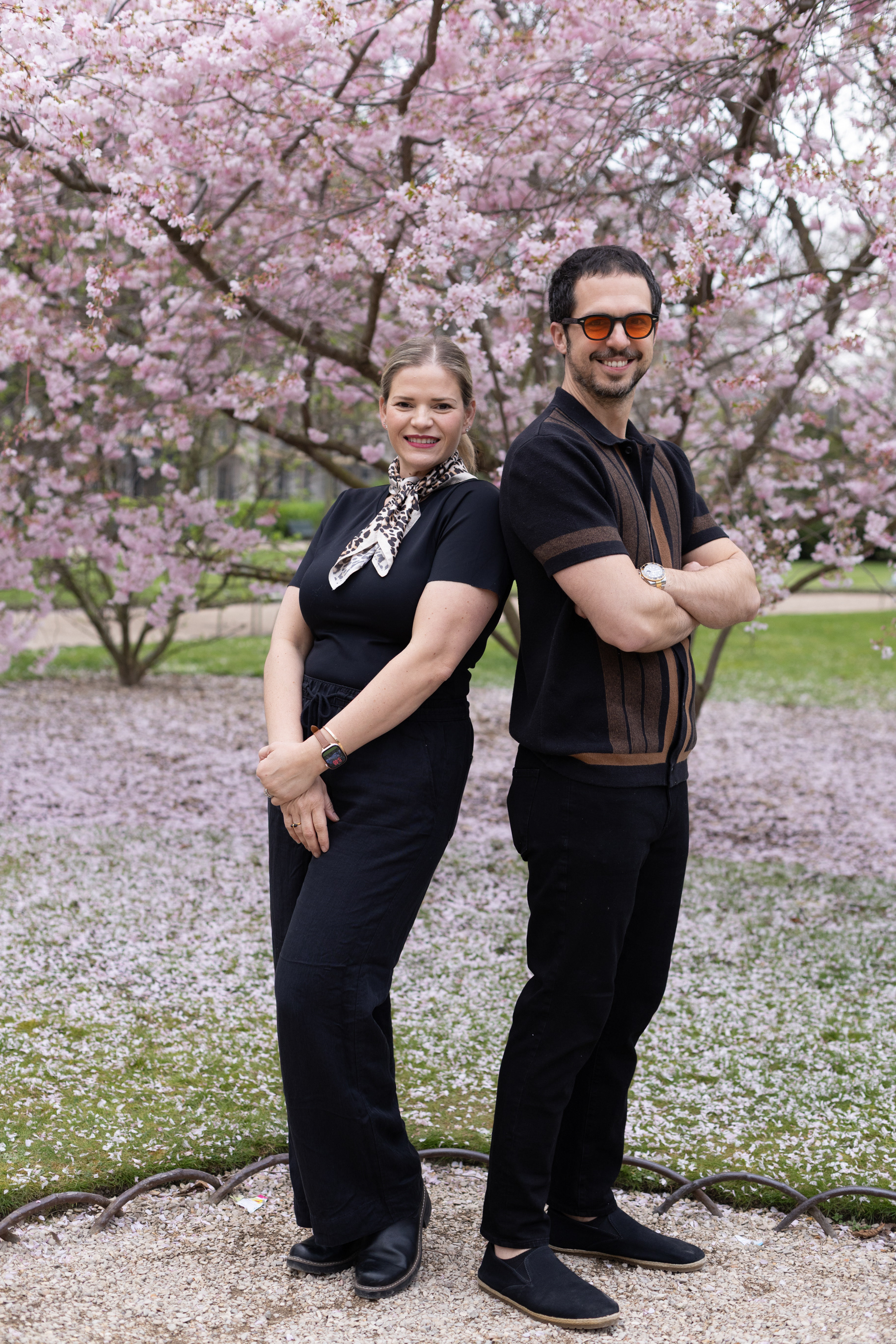  Happy couple, mother and father, during spring cherry blossom season in central Paris.