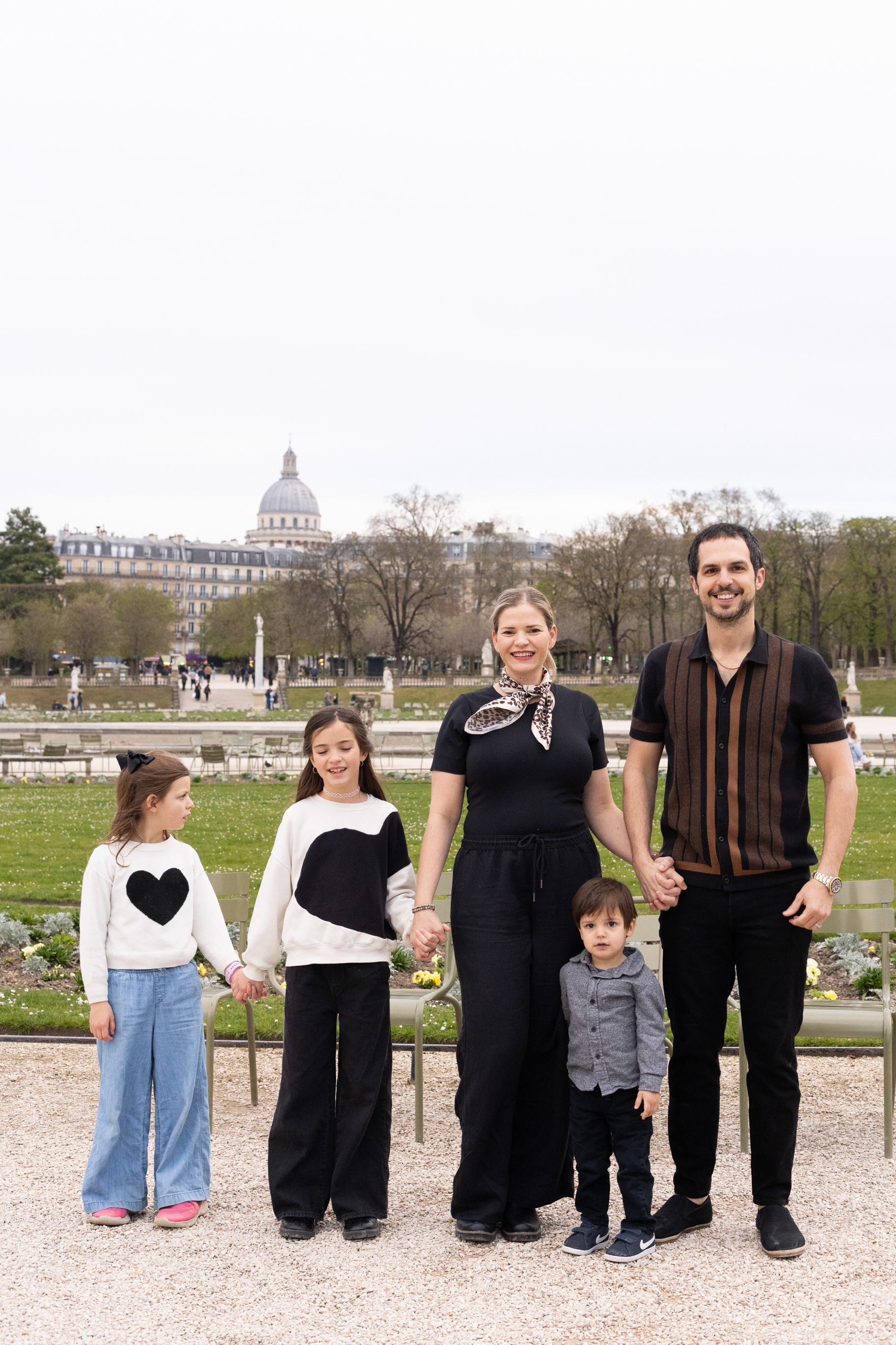 Beautiful view of Luxembourg Garden in spring with blooming flower beds and people strolling through the park