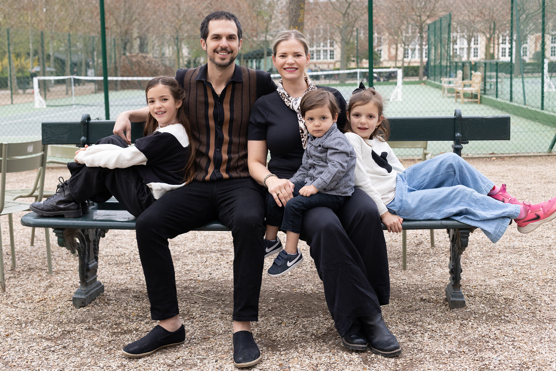 Professional family photoshoot with classic Parisian architecture and the Luxembourg Gardens in the background